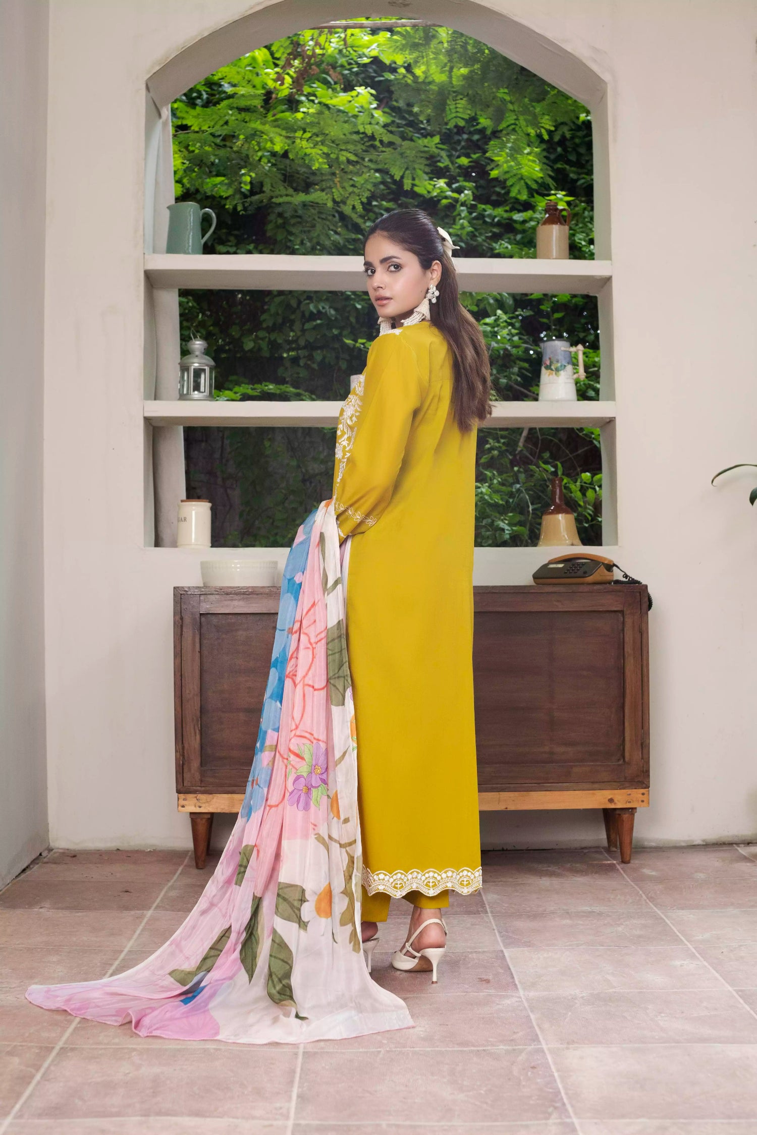 A beautiful mustard embroidered suit with white floral detailing, paired with a vibrant silk dupatta, ideal for festive events.