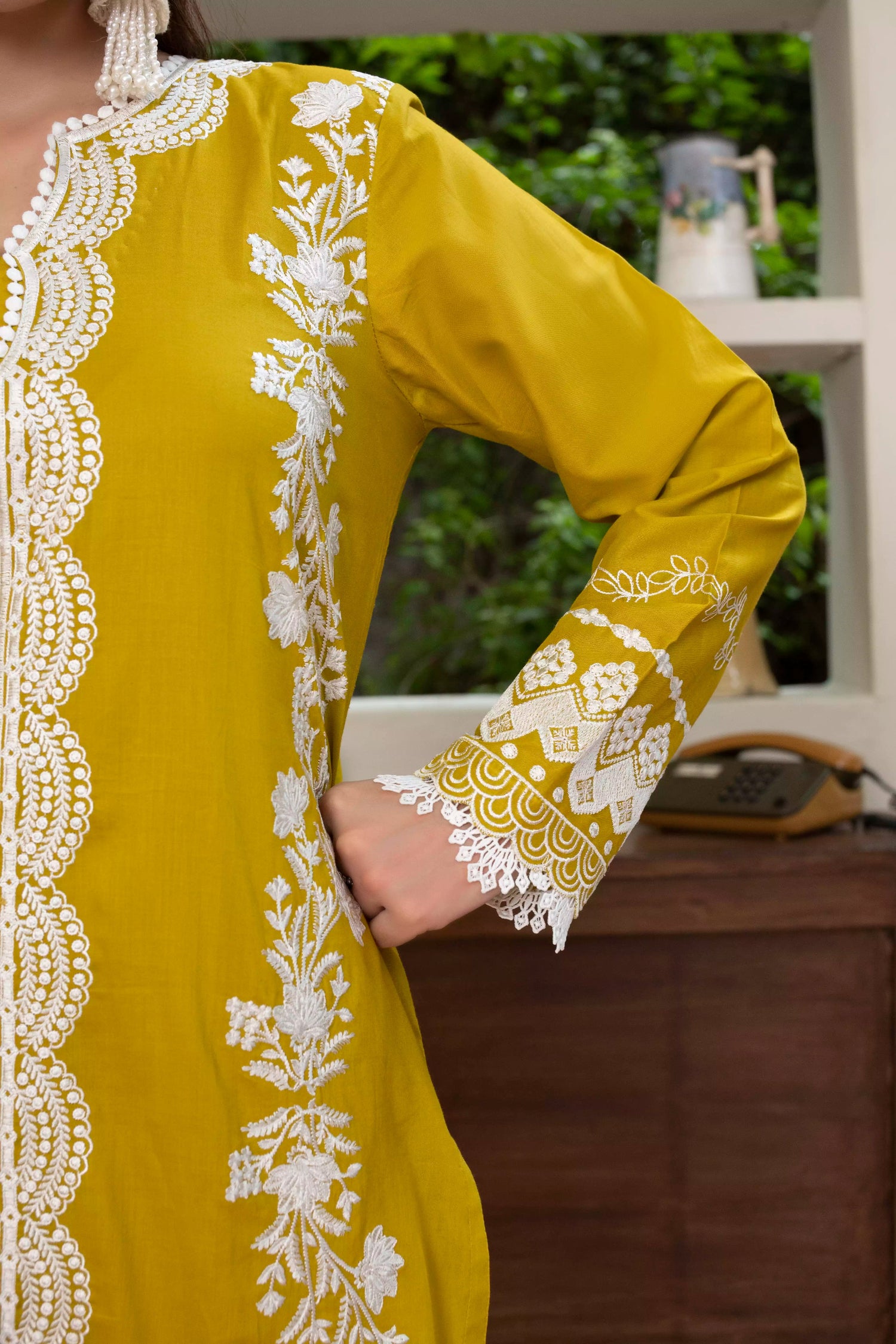 A beautiful mustard embroidered suit with white floral detailing, paired with a vibrant silk dupatta, ideal for festive events.