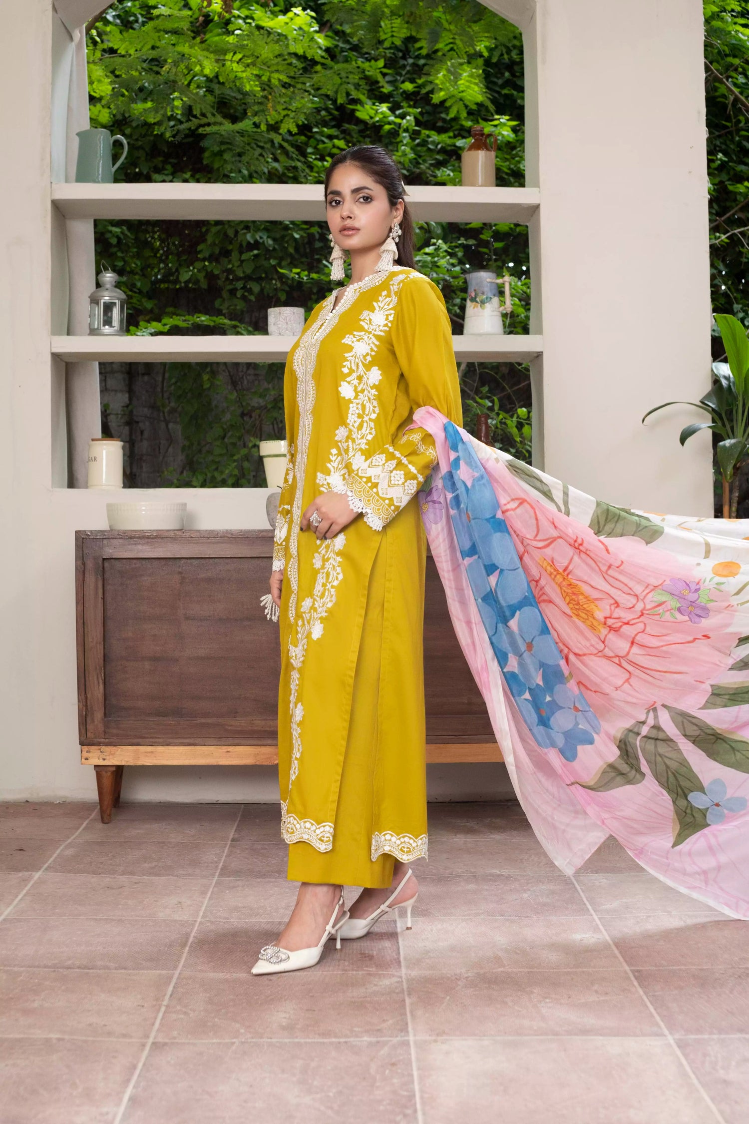 A beautiful mustard embroidered suit with white floral detailing, paired with a vibrant silk dupatta, ideal for festive events.