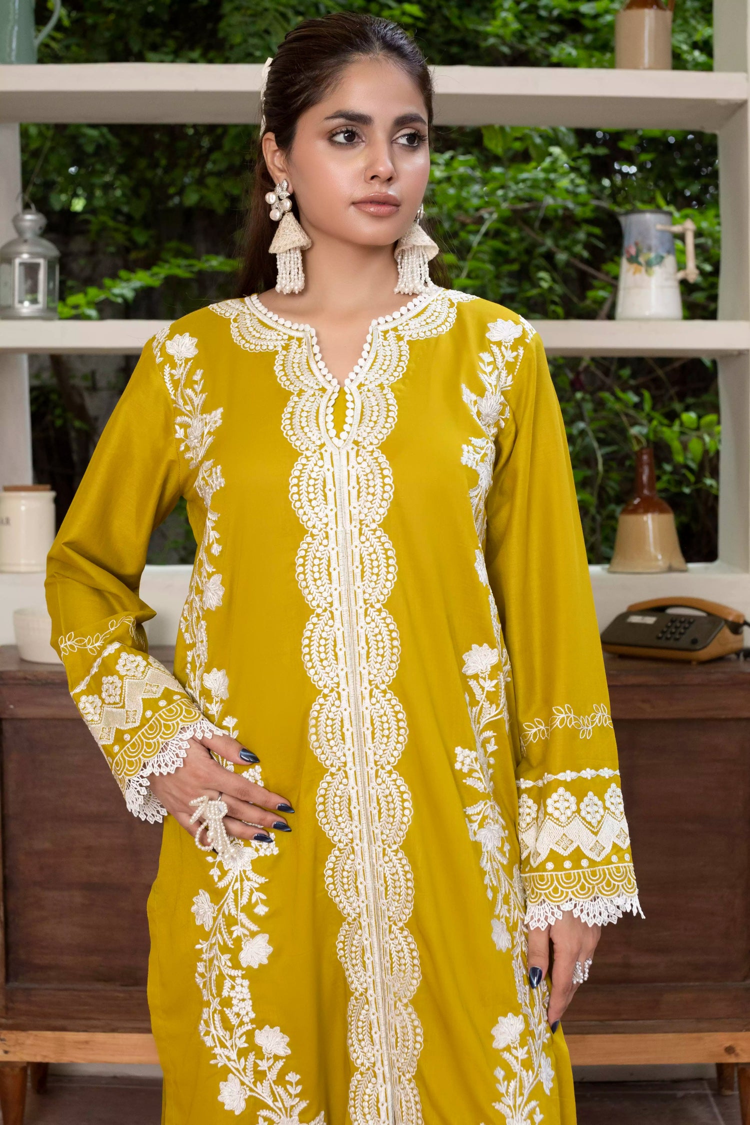 A beautiful mustard embroidered suit with white floral detailing, paired with a vibrant silk dupatta, ideal for festive events.