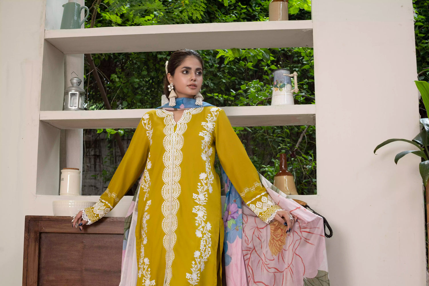 A beautiful mustard embroidered suit with white floral detailing, paired with a vibrant silk dupatta, ideal for festive events.