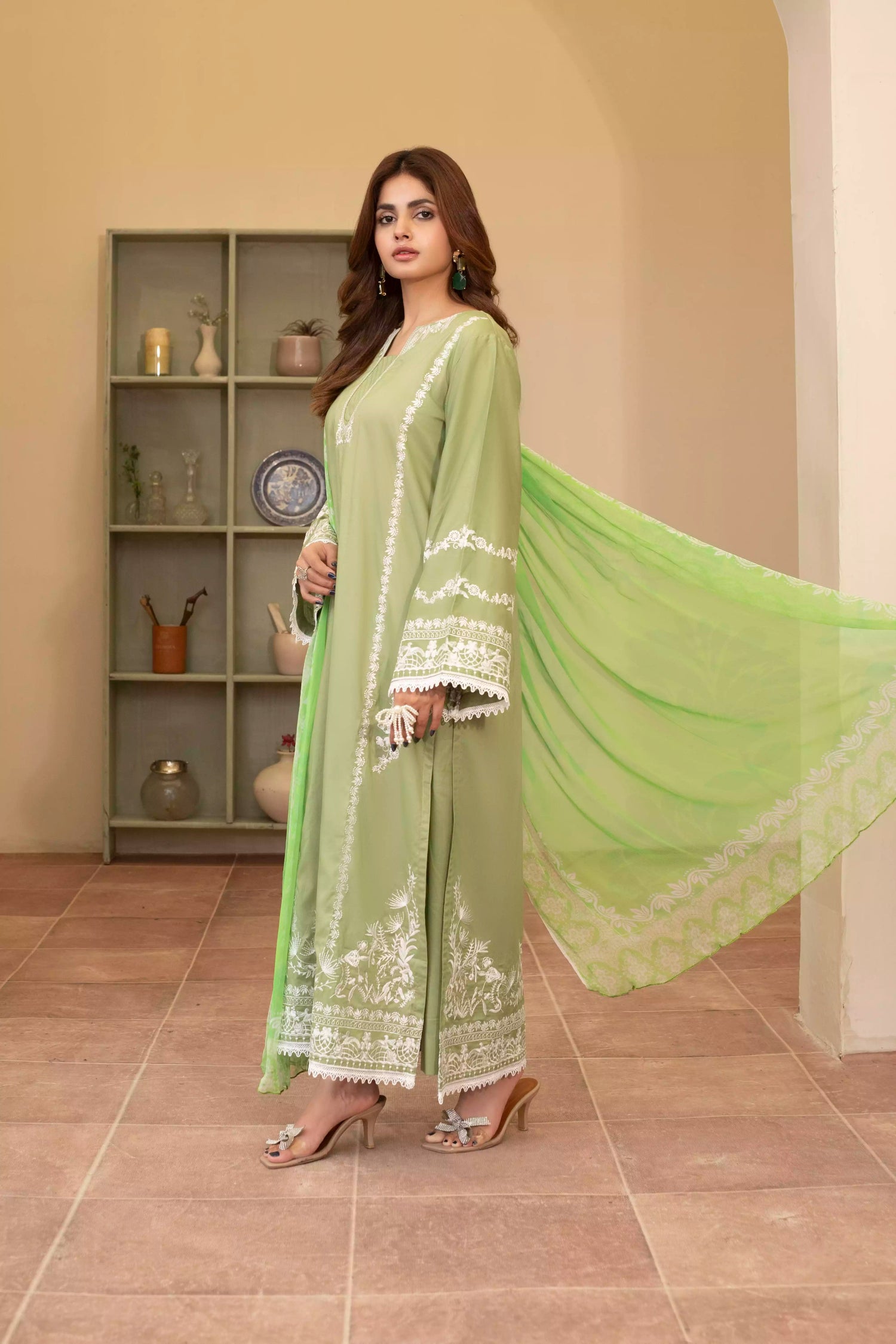 Elegant green embroidered suit with a straight-cut shirt and a breezy green dupatta, perfect for summer occasions.