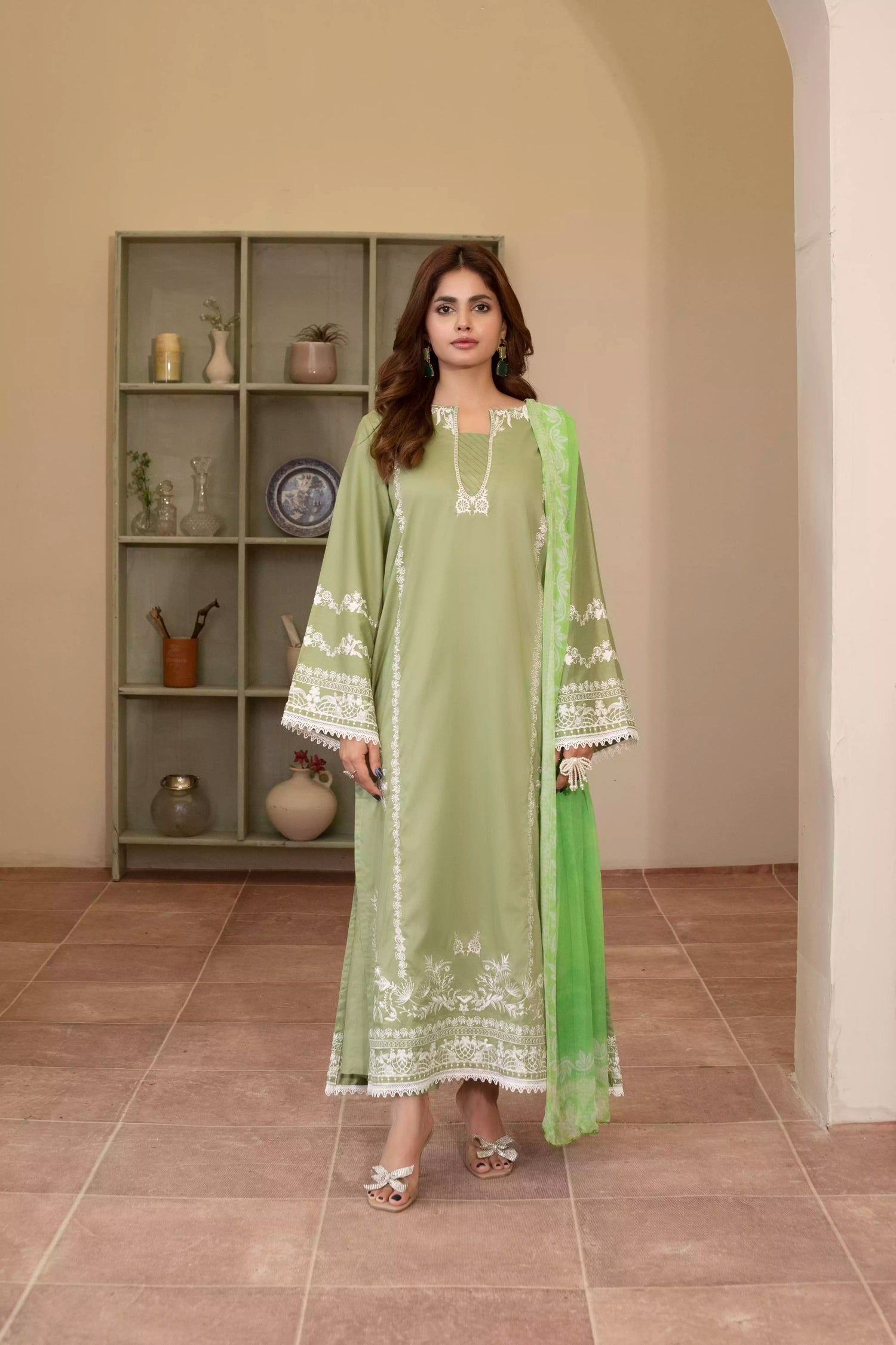 Elegant green embroidered suit with a straight-cut shirt and a breezy green dupatta, perfect for summer occasions.