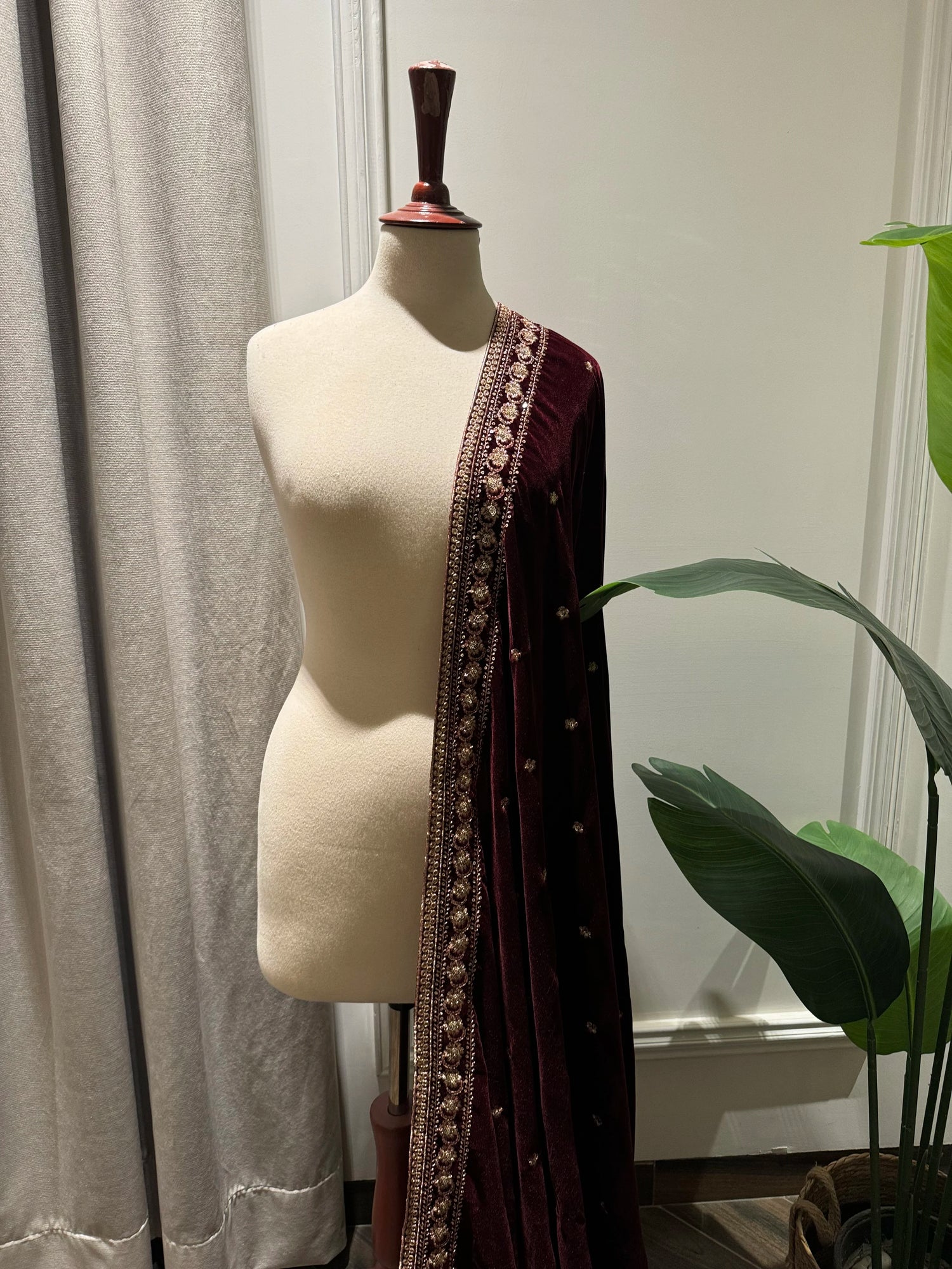 Maroon embroidered velvet shawl features traditional tilla floral work, with delicate motifs ideal for festive look.