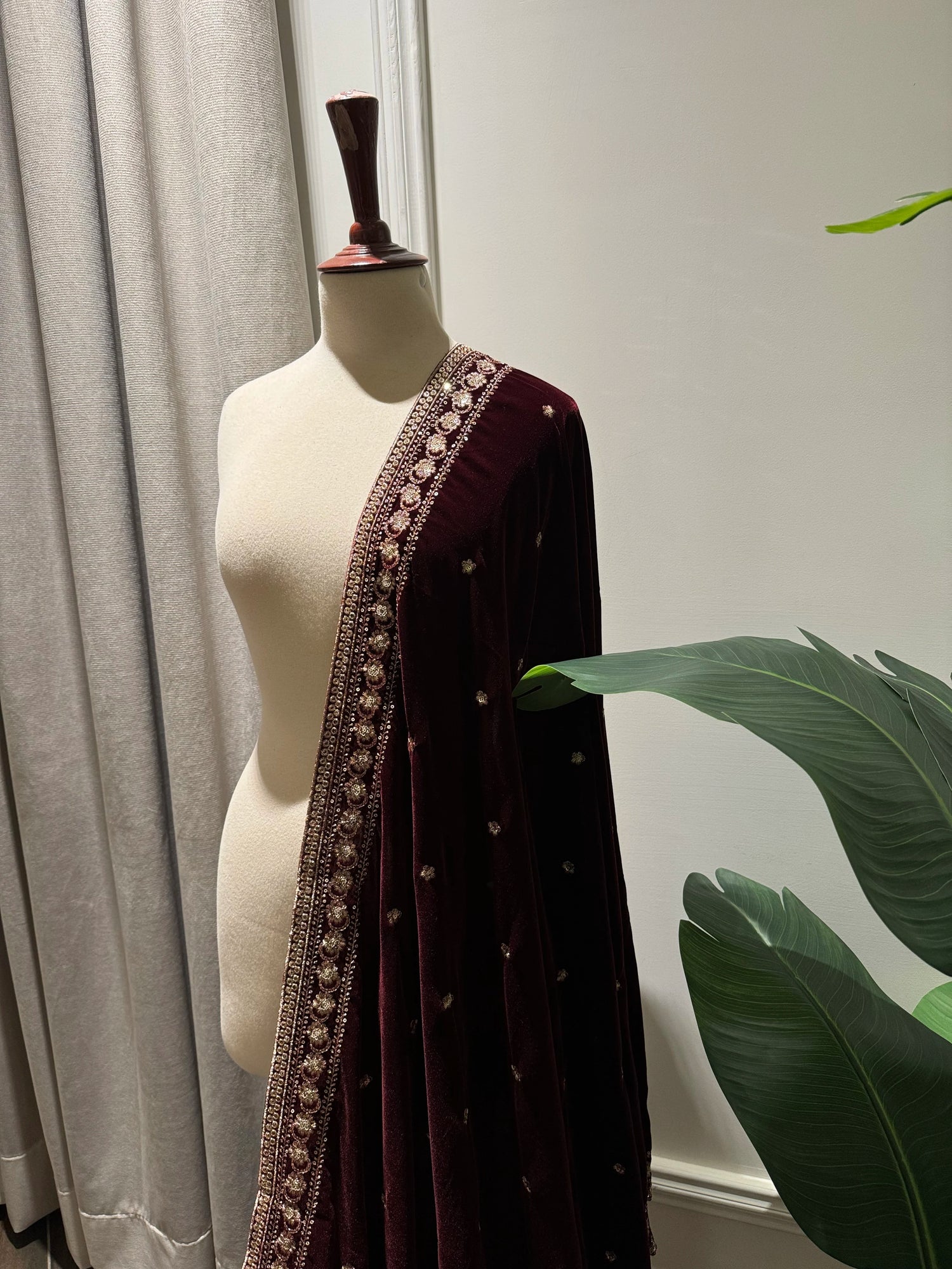 Maroon embroidered velvet shawl features traditional tilla floral work, with delicate motifs ideal for festive look.