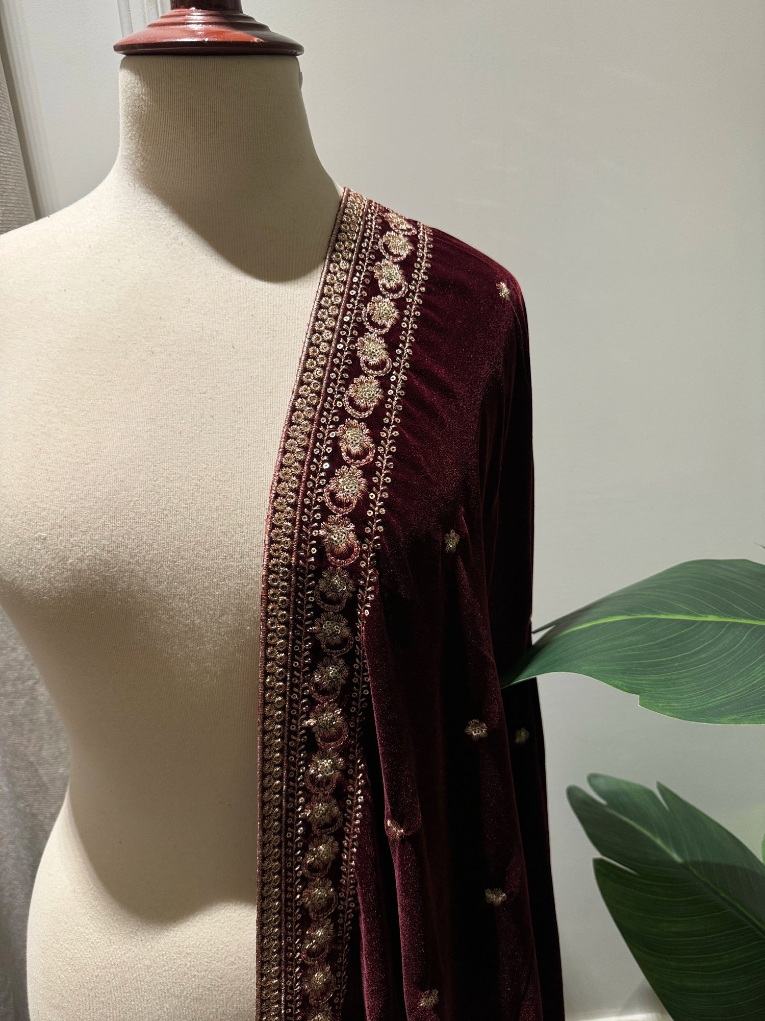 Maroon embroidered velvet shawl features traditional tilla floral work, with delicate motifs ideal for festive look.