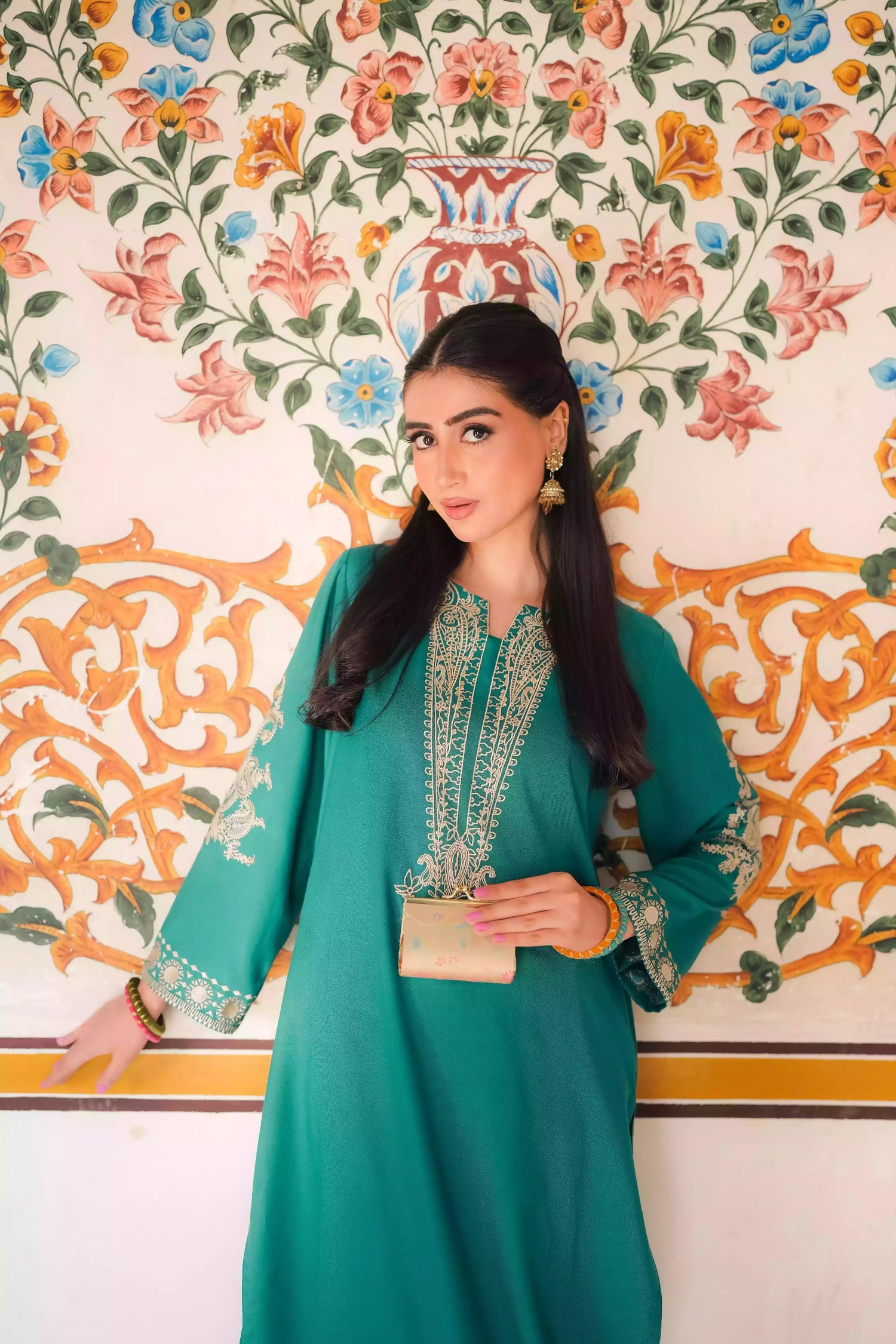 Emerald green kurta featuring intricate gold embroidery on the sleeves and neckline, with motifs inspired by classical heritage design. Offering an elegant and timeless style suitable for festive or cultural occasions.