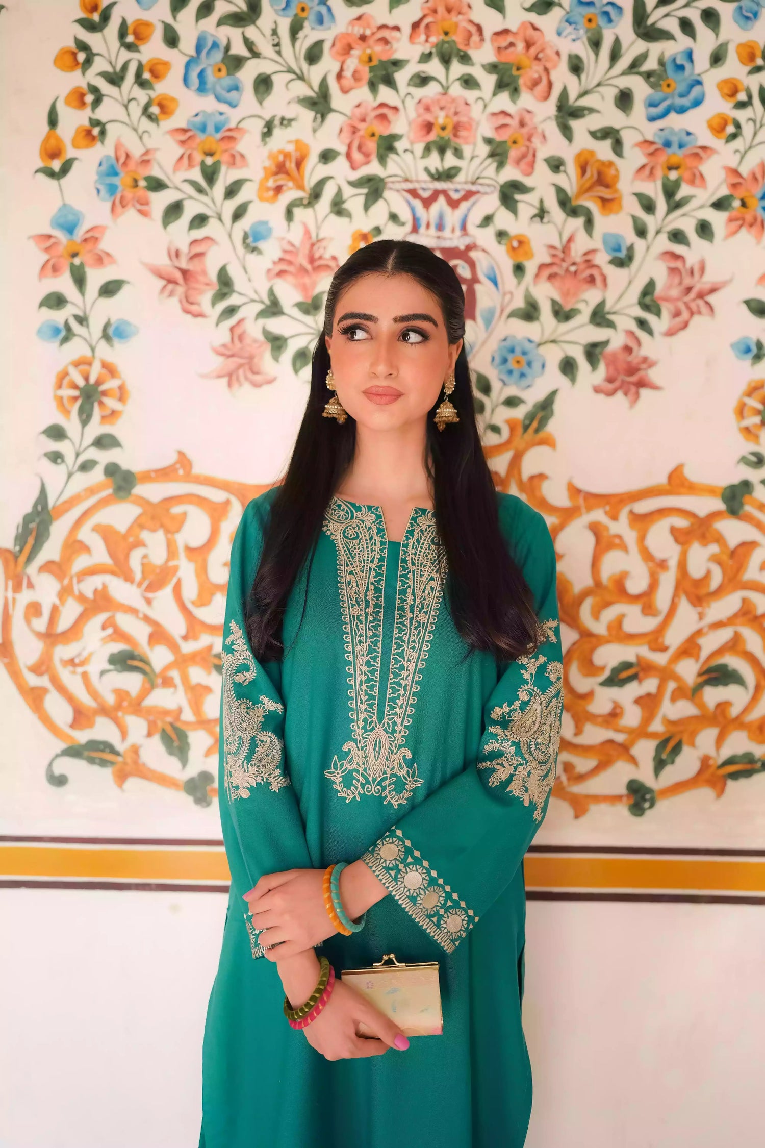 Emerald green kurta featuring intricate gold embroidery on the sleeves and neckline, with motifs inspired by classical heritage design. Offering an elegant and timeless style suitable for festive or cultural occasions.