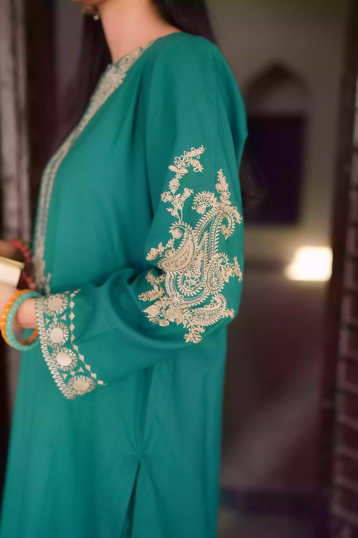 Emerald green kurta featuring intricate gold embroidery on the sleeves and neckline, with motifs inspired by classical heritage design. Offering an elegant and timeless style suitable for festive or cultural occasions.