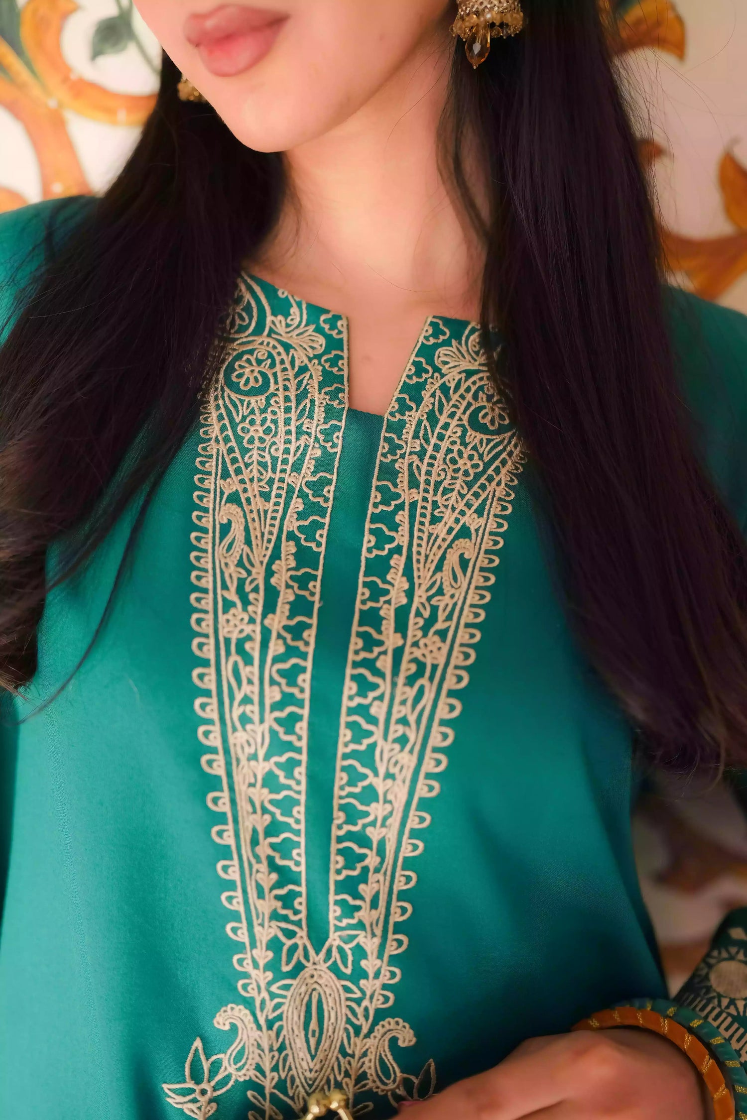 Emerald green kurta featuring intricate gold embroidery on the sleeves and neckline, with motifs inspired by classical heritage design. Offering an elegant and timeless style suitable for festive or cultural occasions.