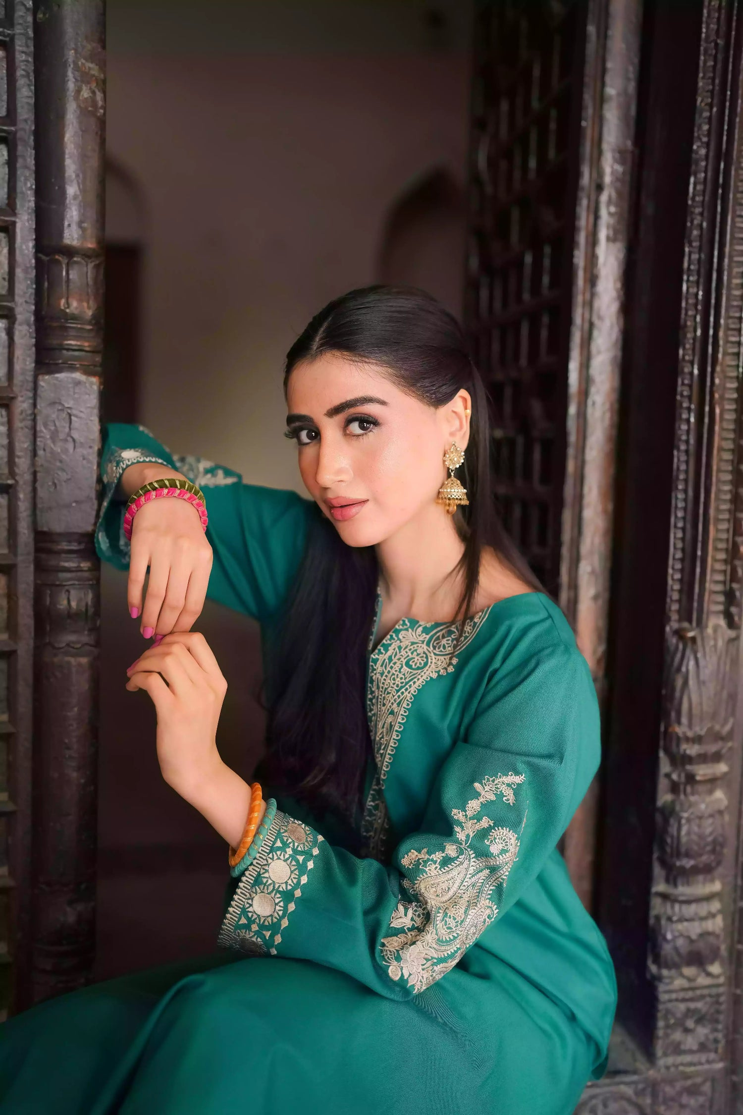 Emerald green kurta featuring intricate gold embroidery on the sleeves and neckline, with motifs inspired by classical heritage design. Offering an elegant and timeless style suitable for festive or cultural occasions.