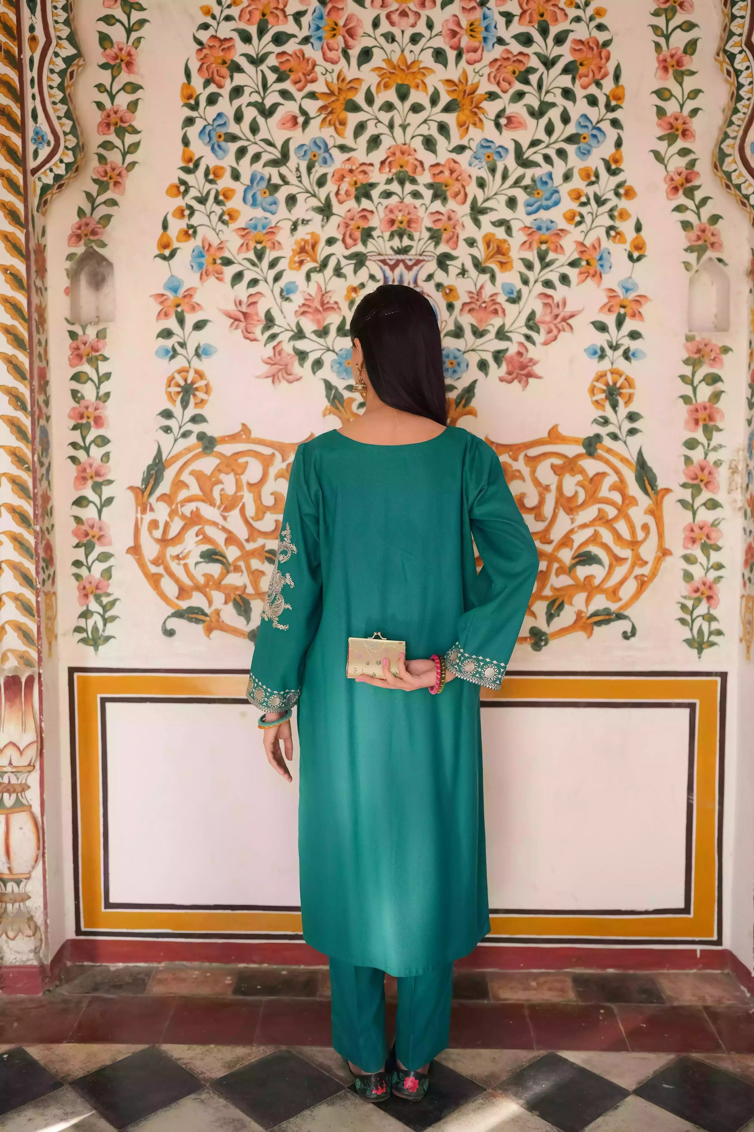 Emerald green kurta featuring intricate gold embroidery on the sleeves and neckline, with motifs inspired by classical heritage design. Offering an elegant and timeless style suitable for festive or cultural occasions.