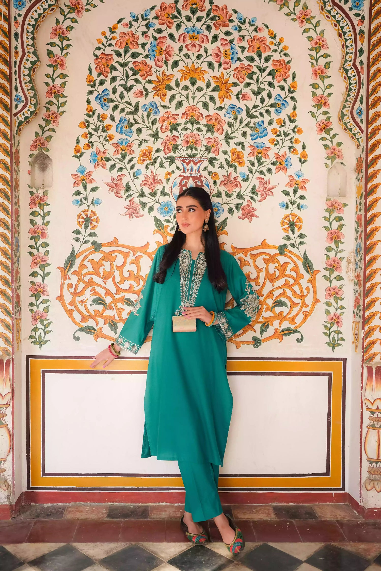 Emerald green kurta featuring intricate gold embroidery on the sleeves and neckline, with motifs inspired by classical heritage design. Offering an elegant and timeless style suitable for festive or cultural occasions.