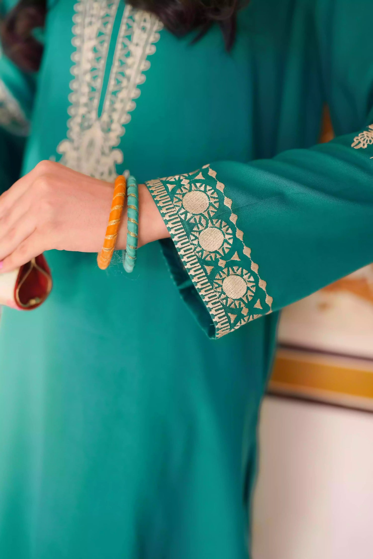 Emerald green kurta featuring intricate gold embroidery on the sleeves and neckline, with motifs inspired by classical heritage design. Offering an elegant and timeless style suitable for festive or cultural occasions.