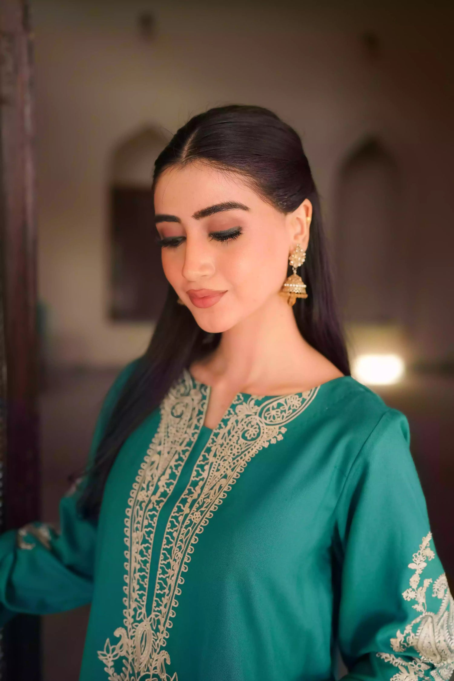 Emerald green kurta featuring intricate gold embroidery on the sleeves and neckline, with motifs inspired by classical heritage design. Offering an elegant and timeless style suitable for festive or cultural occasions.