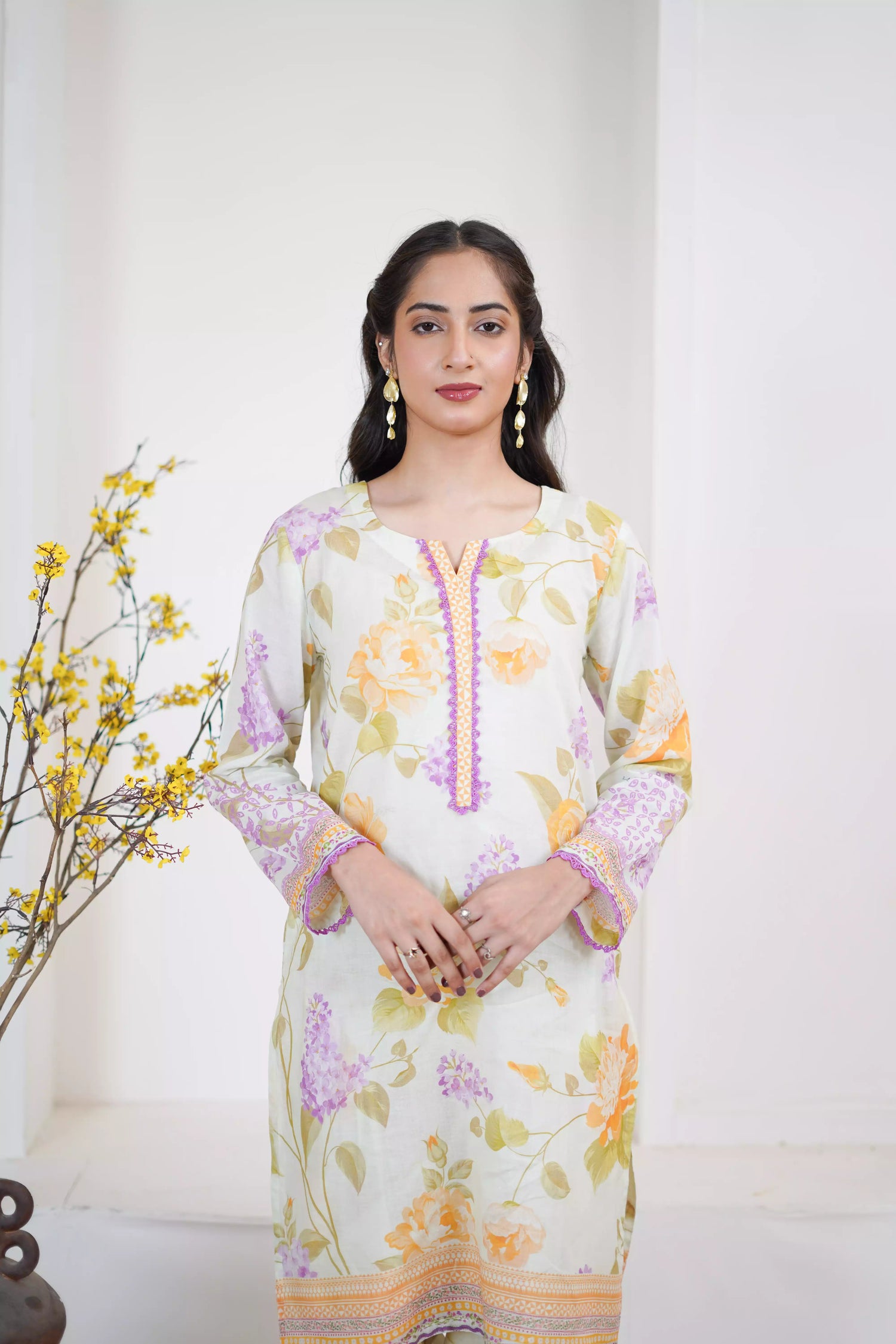 Lightweight kurta adorned with yellow and lilac flowers, capturing the essence of summer's blooming gardens.