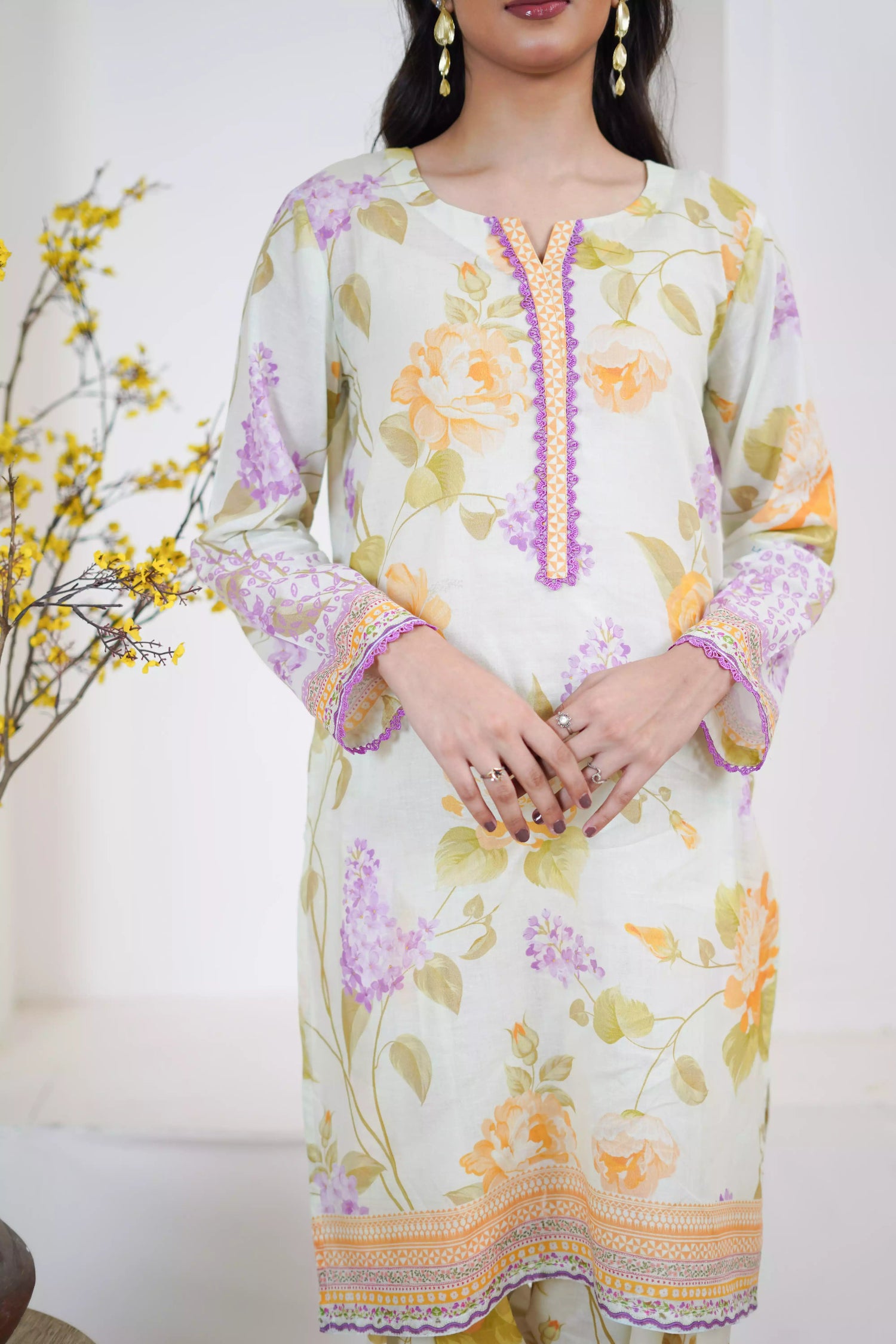 Lightweight kurta adorned with yellow and lilac flowers, capturing the essence of summer's blooming gardens.