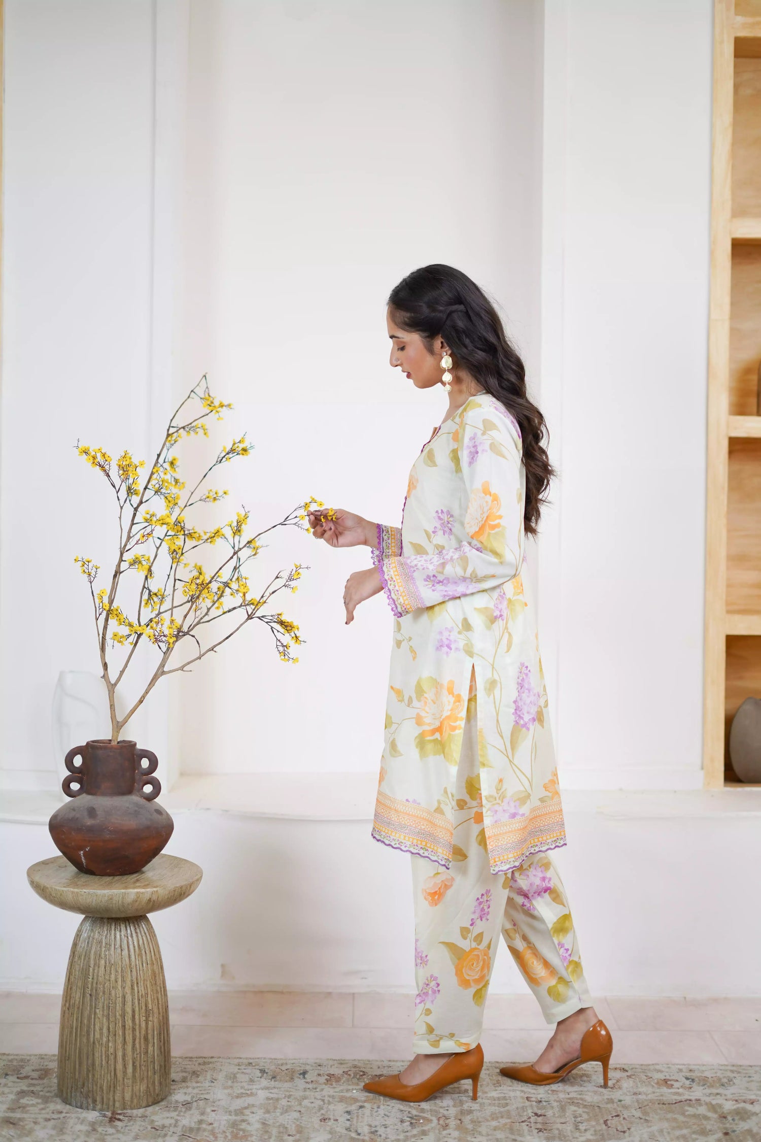 Lightweight kurta adorned with yellow and lilac flowers, capturing the essence of summer's blooming gardens.