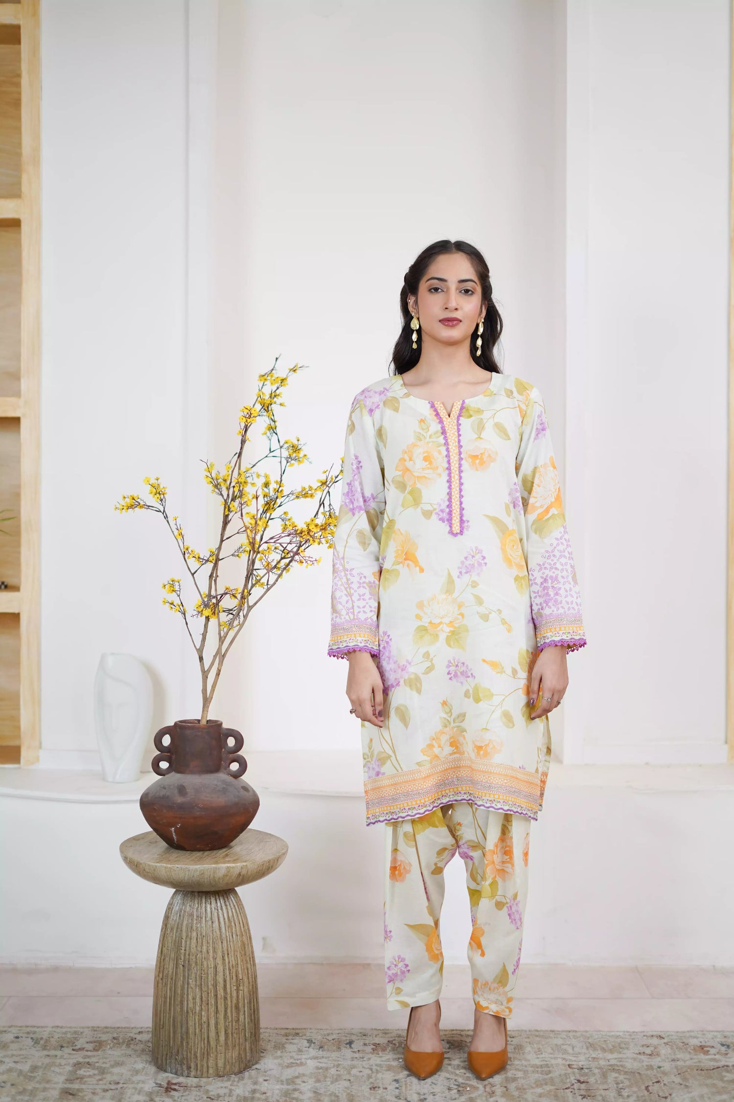 Lightweight kurta adorned with yellow and lilac flowers, capturing the essence of summer's blooming gardens.