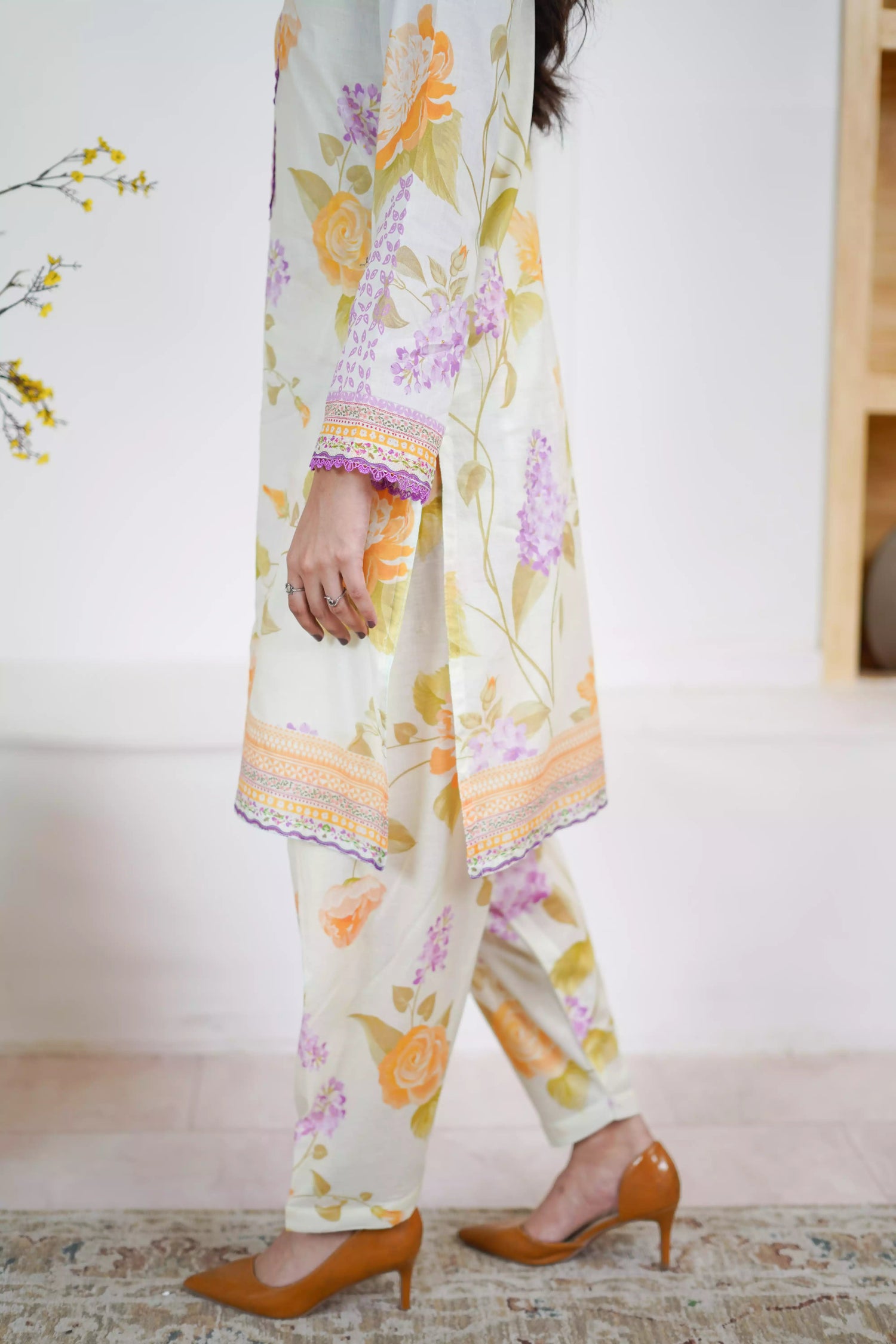 Lightweight kurta adorned with yellow and lilac flowers, capturing the essence of summer's blooming gardens.