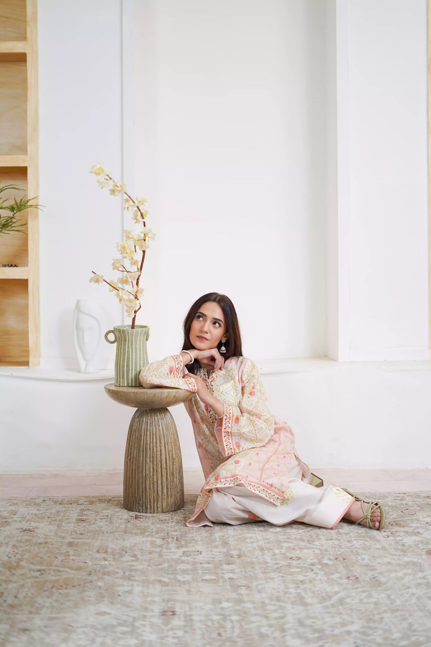 Elegant floral print with pink tulips and green vines on soft pastel fabric. Features fine borders and a graceful, symmetrical design for festive or casual wear.
