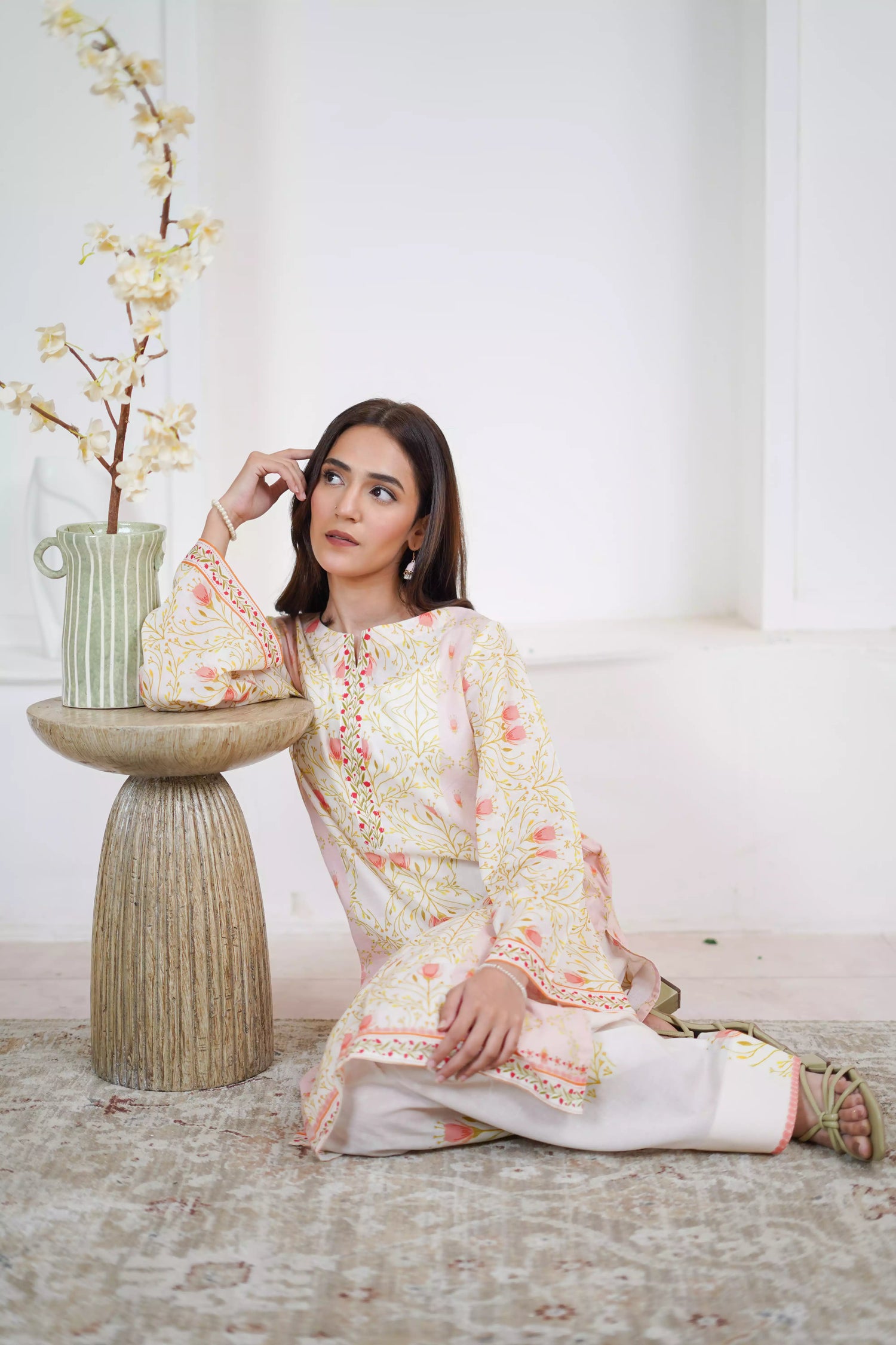 Elegant floral print with pink tulips and green vines on soft pastel fabric. Features fine borders and a graceful, symmetrical design for festive or casual wear.