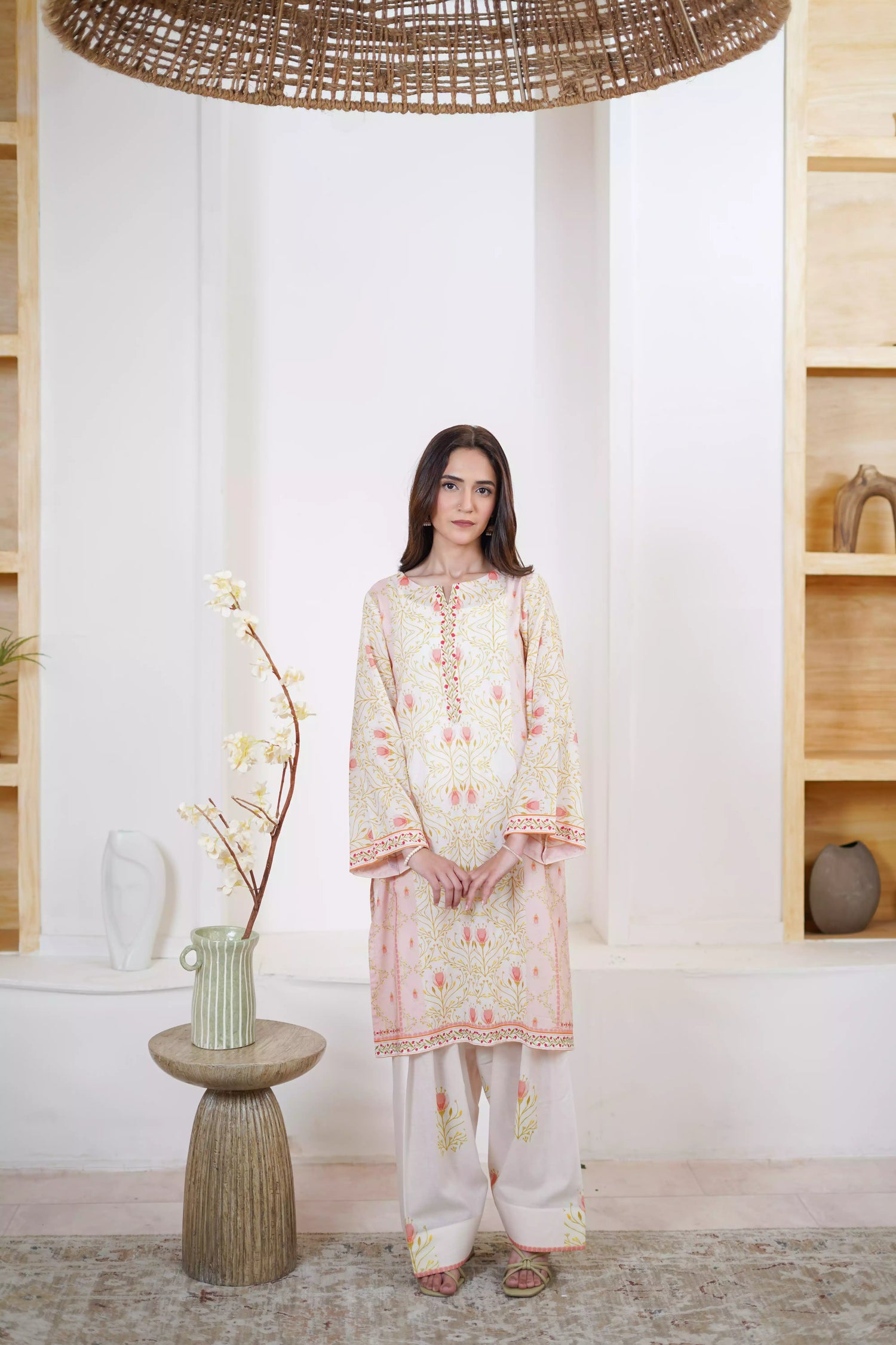 Elegant floral print with pink tulips and green vines on soft pastel fabric. Features fine borders and a graceful, symmetrical design for festive or casual wear.