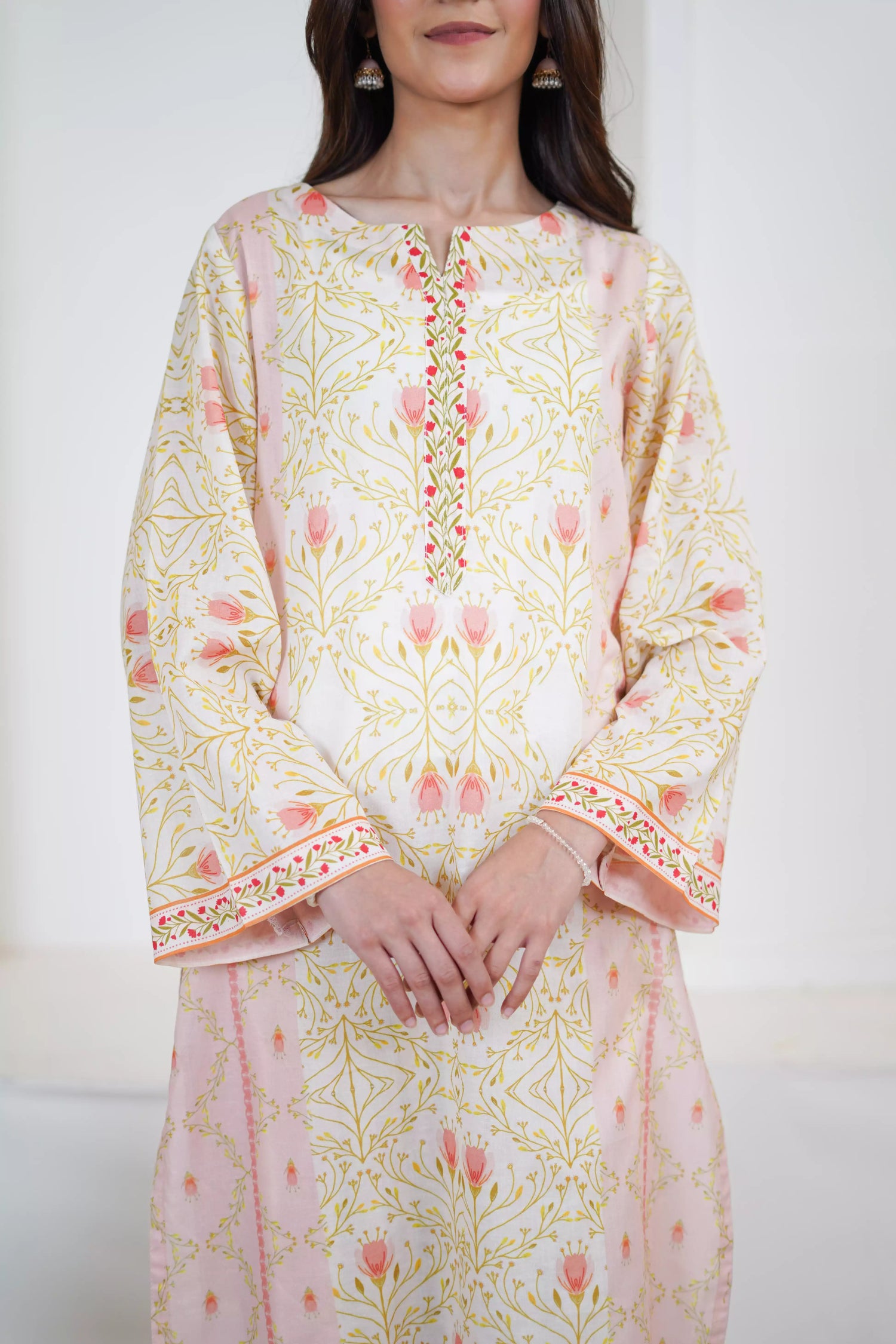 Elegant floral print with pink tulips and green vines on soft pastel fabric. Features fine borders and a graceful, symmetrical design for festive or casual wear.