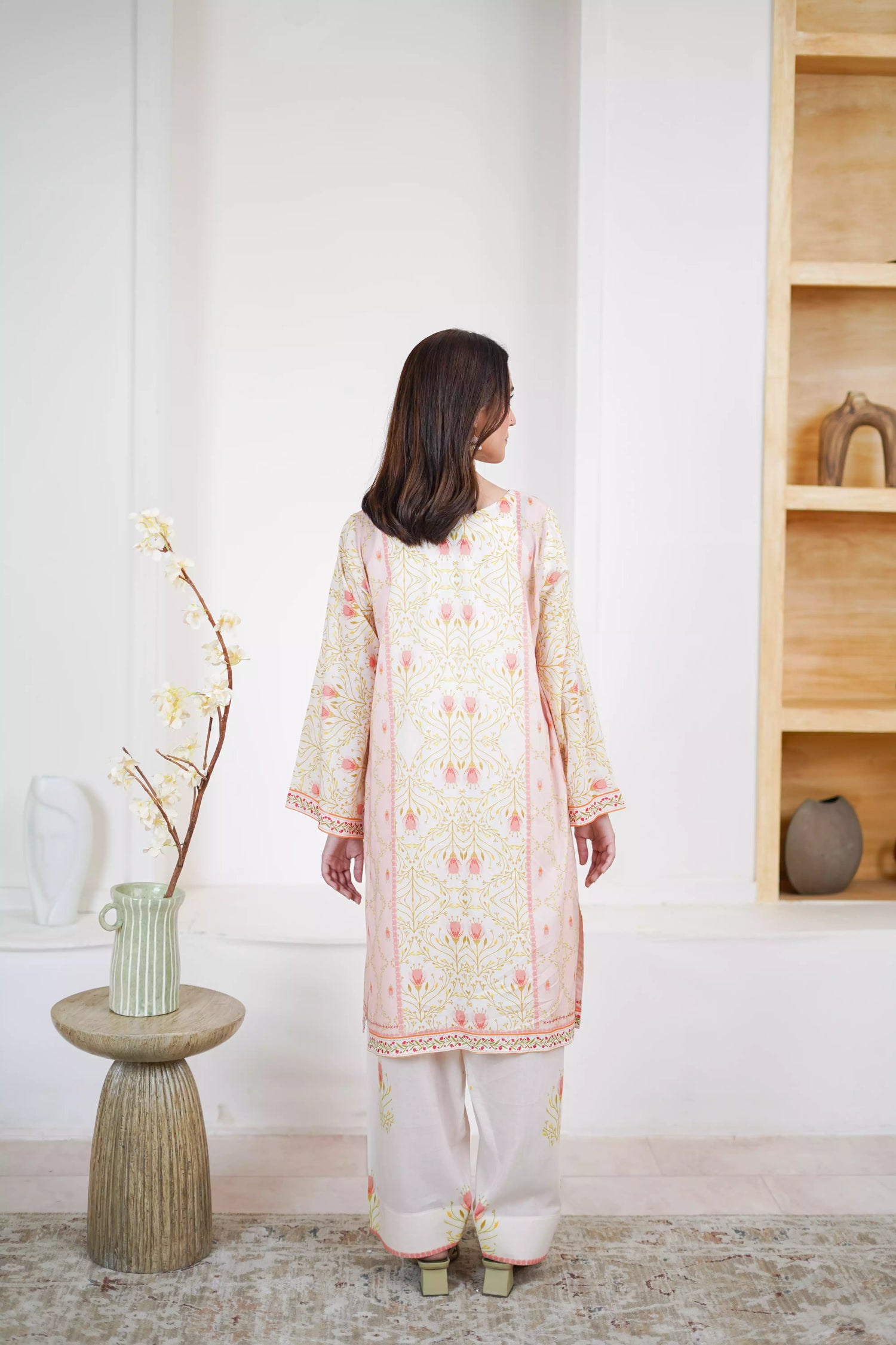 Elegant floral print with pink tulips and green vines on soft pastel fabric. Features fine borders and a graceful, symmetrical design for festive or casual wear.