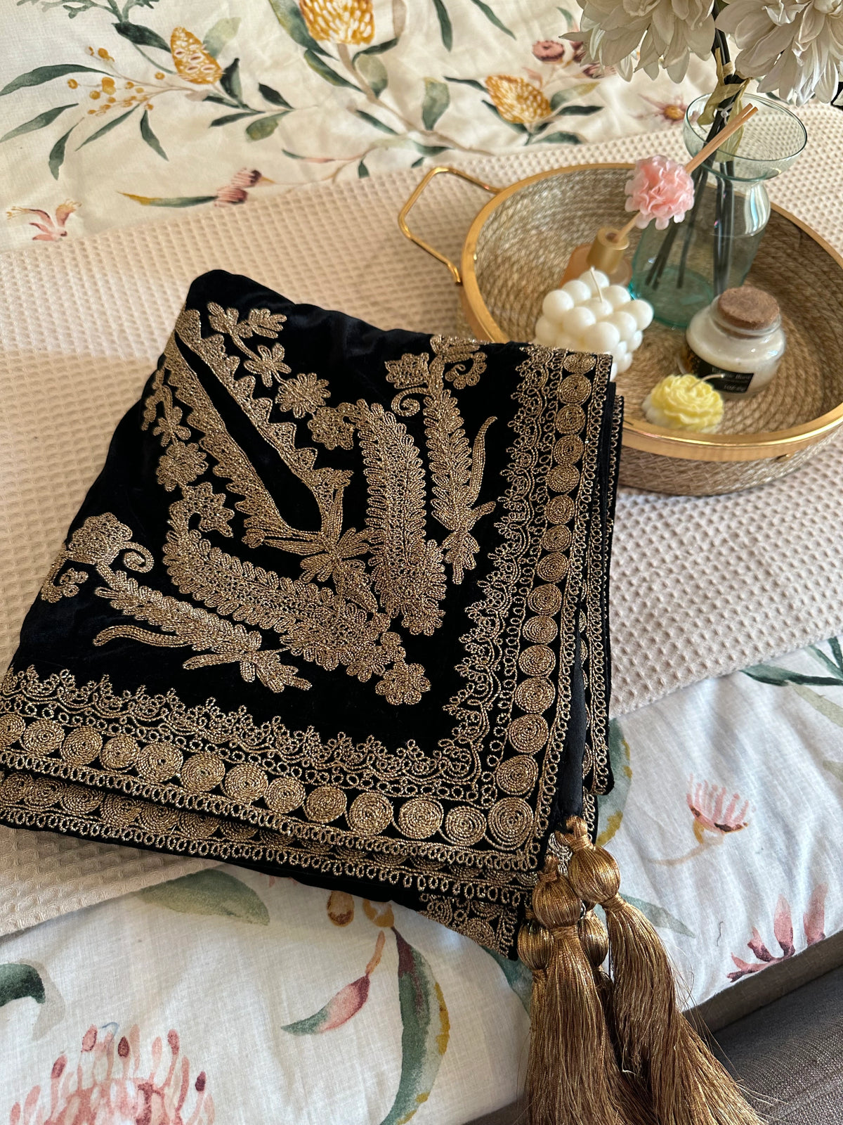 Luxurious black velvet shawl featuring detailed gold embroidery along the borders and corners, offering an elegant drape perfect for festive events and formal occasions.