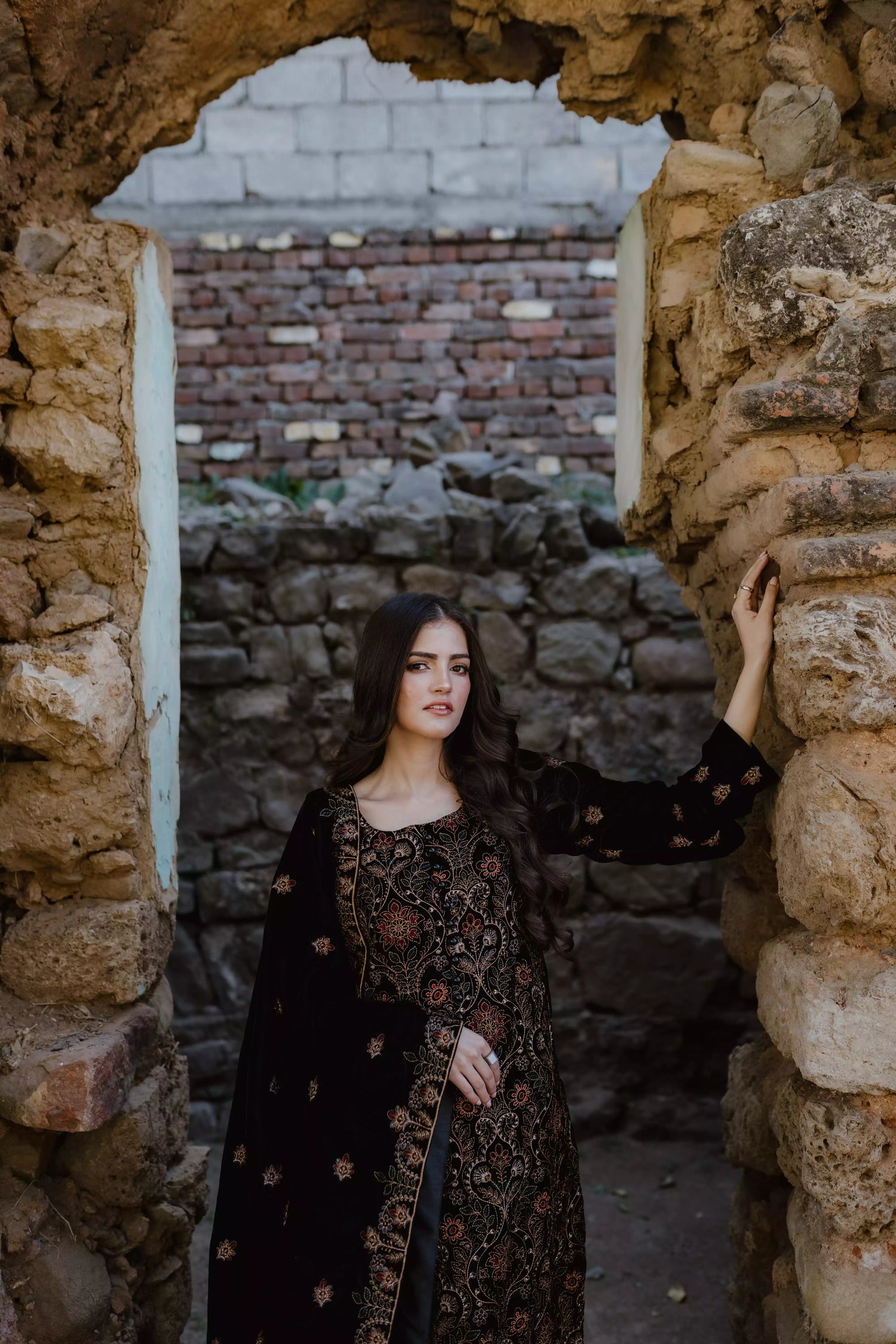 Black velvet suit features intricate multi-thread embroidery on the shirt, paired with plain velvet pants and a matching velvet shawl with embroidered borders for a refined, luxurious look.