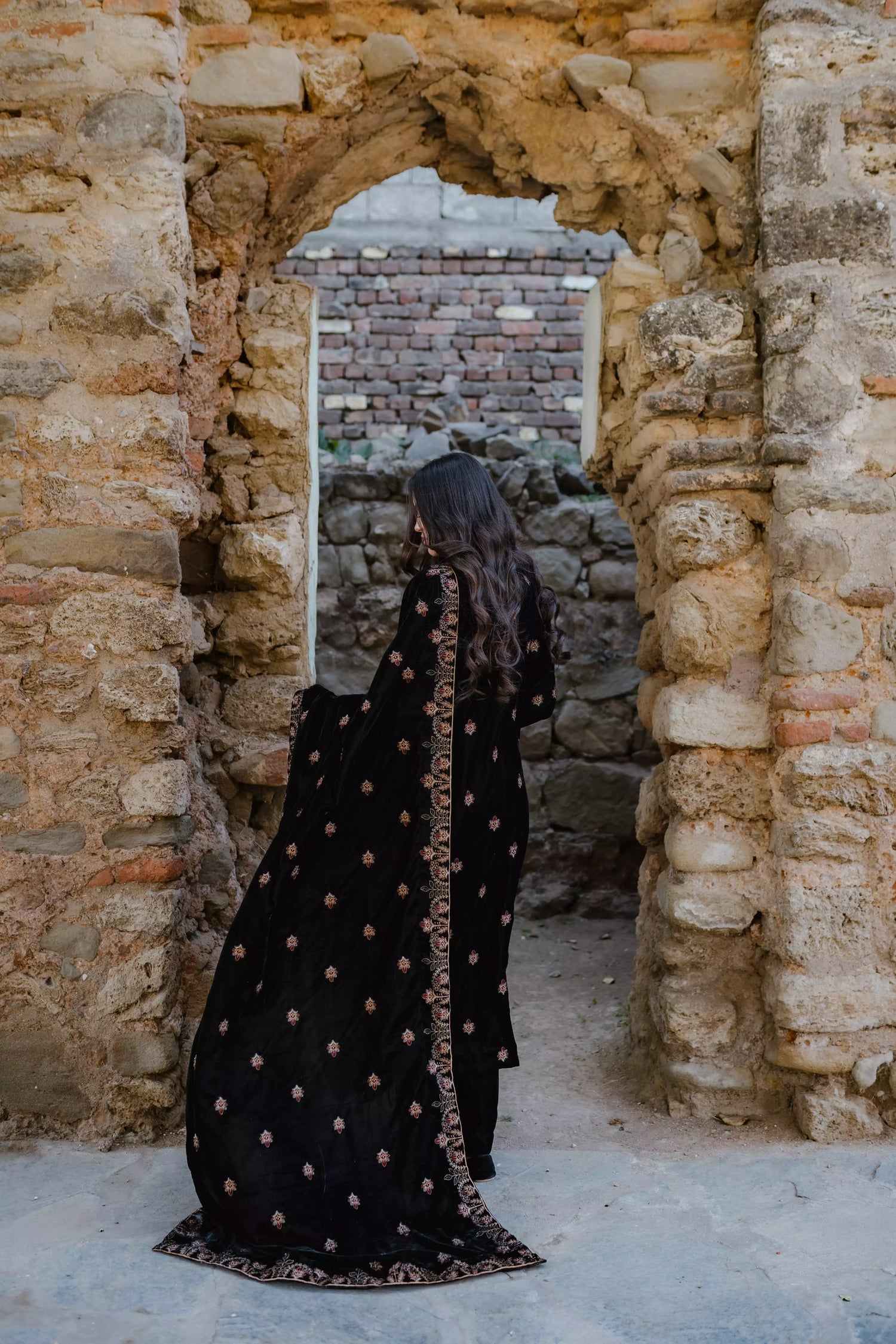 Black velvet suit features intricate multi-thread embroidery on the shirt, paired with plain velvet pants and a matching velvet shawl with embroidered borders for a refined, luxurious look.