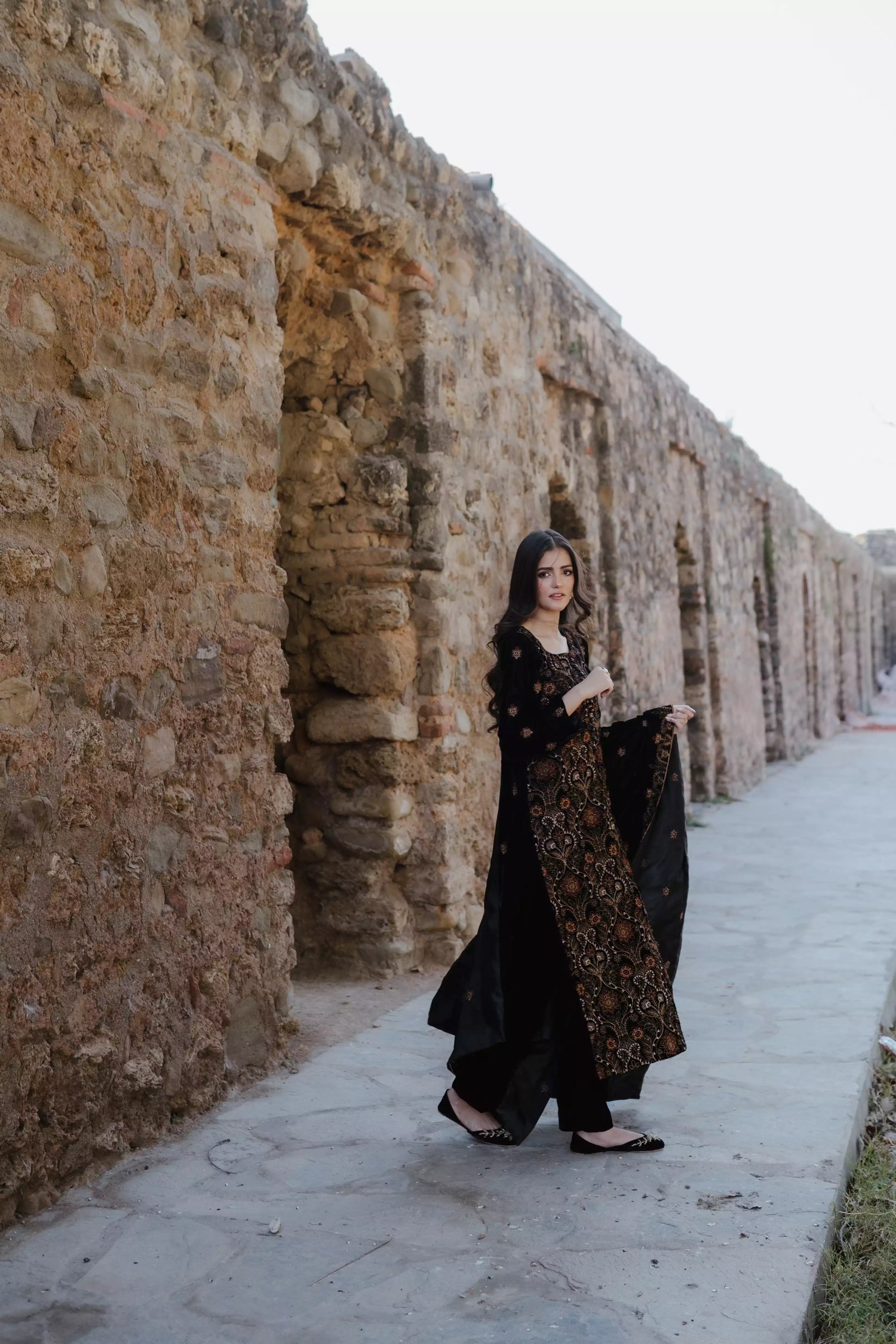 Black velvet suit features intricate multi-thread embroidery on the shirt, paired with plain velvet pants and a matching velvet shawl with embroidered borders for a refined, luxurious look.