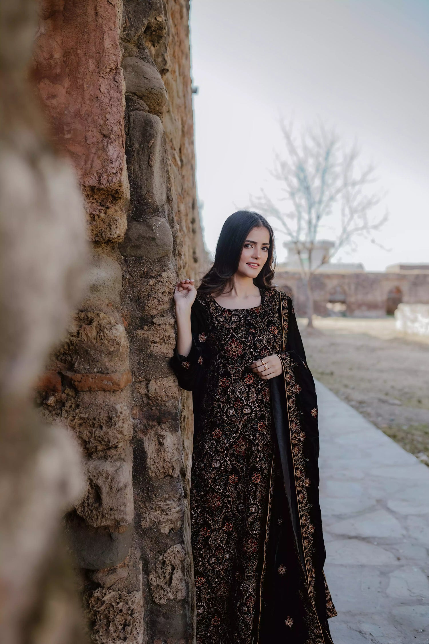 Black velvet suit features intricate multi-thread embroidery on the shirt, paired with plain velvet pants and a matching velvet shawl with embroidered borders for a refined, luxurious look.