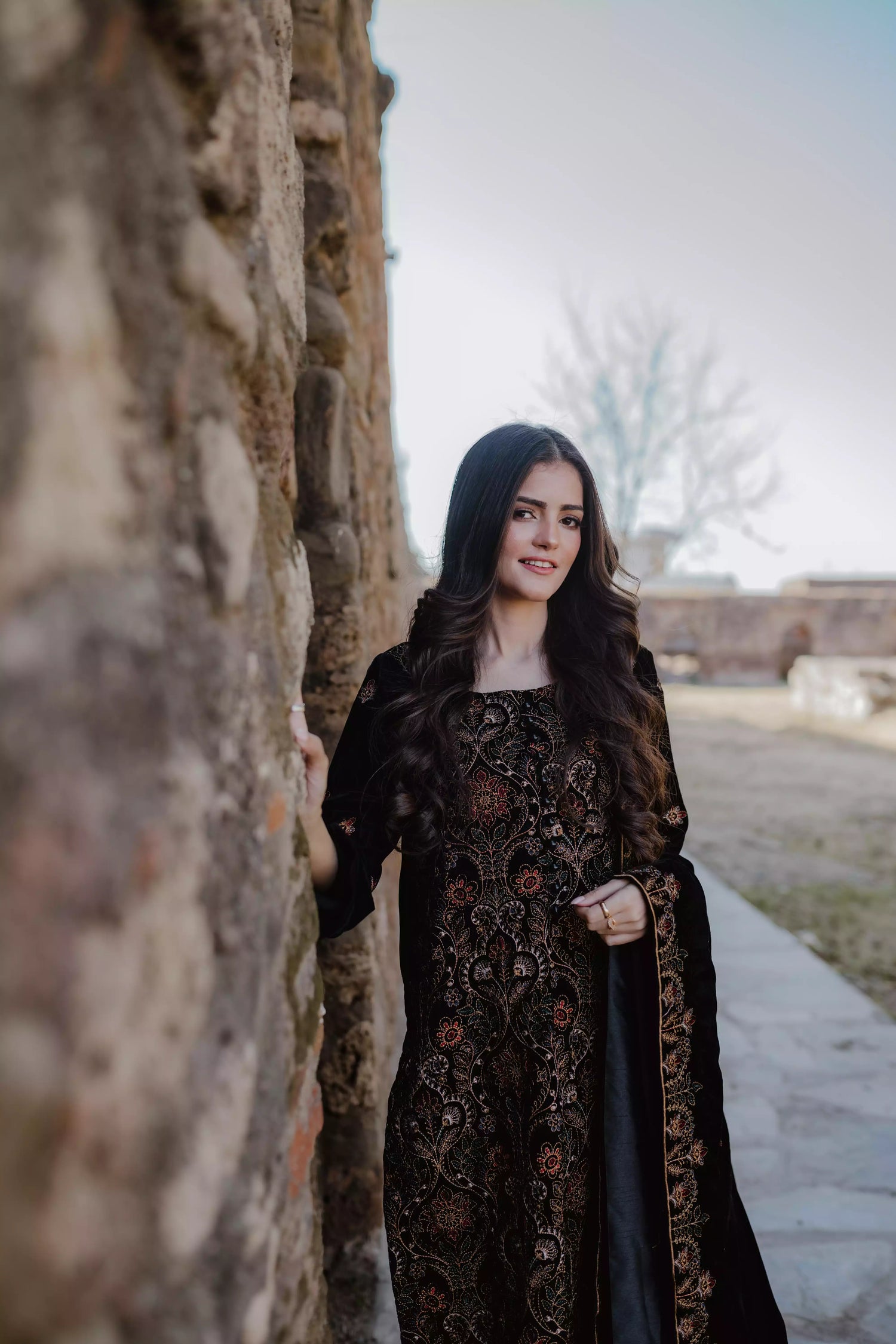 Black velvet suit features intricate multi-thread embroidery on the shirt, paired with plain velvet pants and a matching velvet shawl with embroidered borders for a refined, luxurious look.