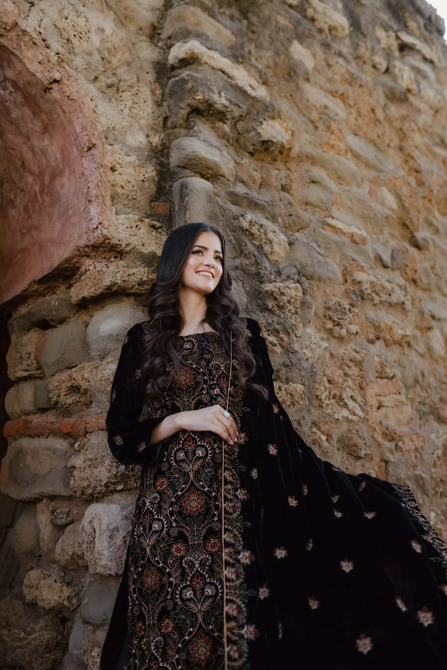 Black velvet suit features intricate multi-thread embroidery on the shirt, paired with plain velvet pants and a matching velvet shawl with embroidered borders for a refined, luxurious look.