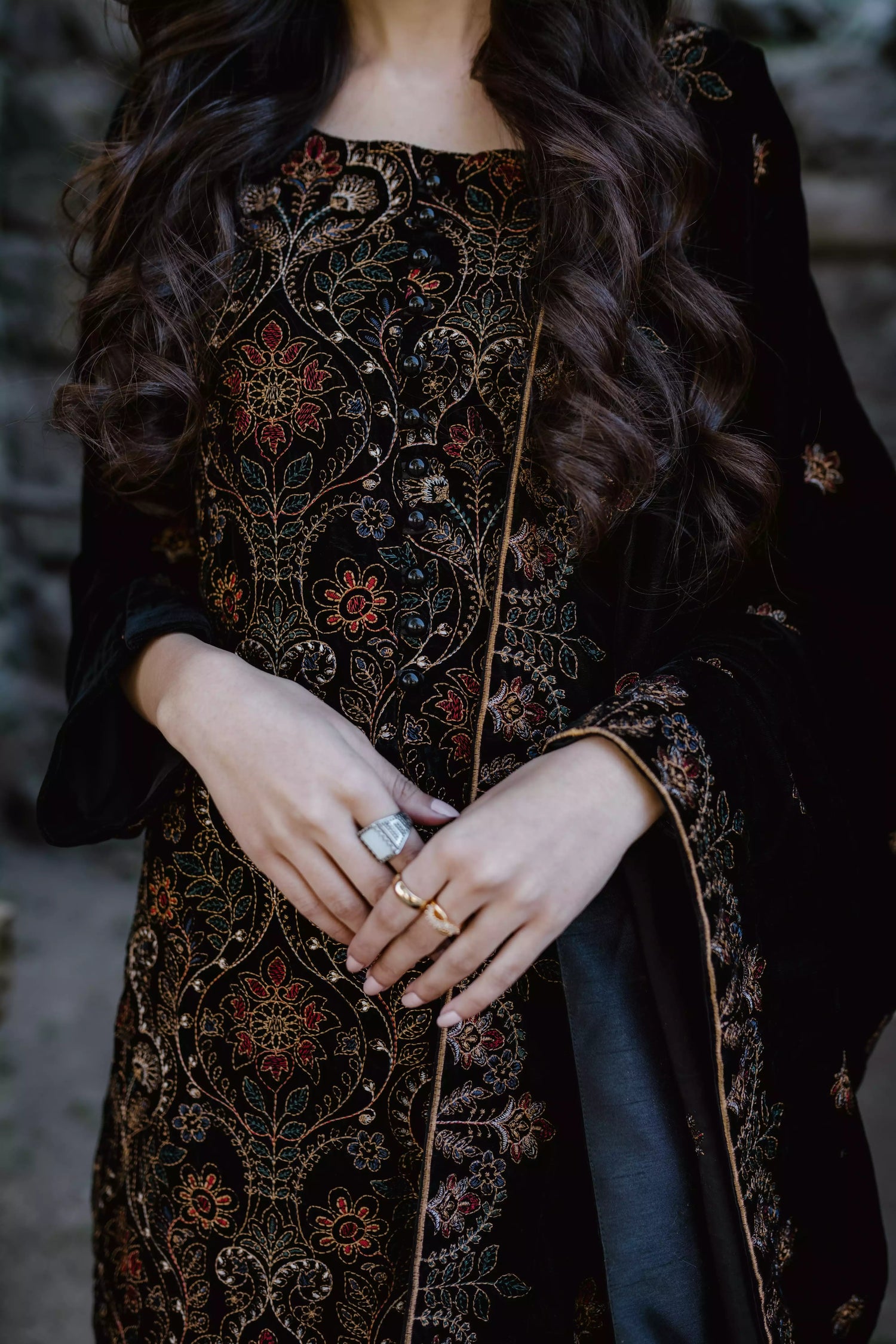 Black velvet suit features intricate multi-thread embroidery on the shirt, paired with plain velvet pants and a matching velvet shawl with embroidered borders for a refined, luxurious look.