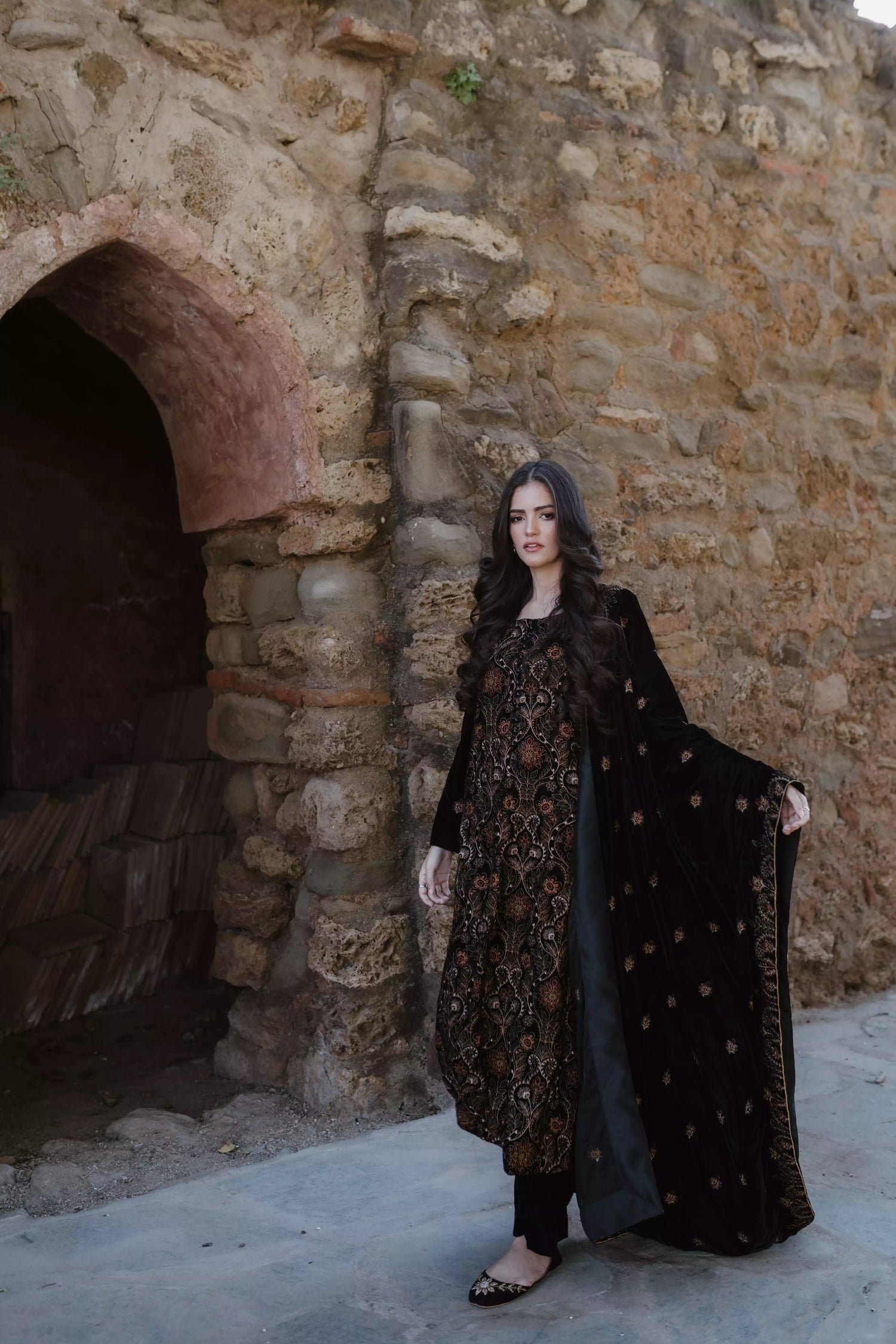 Black velvet suit features intricate multi-thread embroidery on the shirt, paired with plain velvet pants and a matching velvet shawl with embroidered borders for a refined, luxurious look.