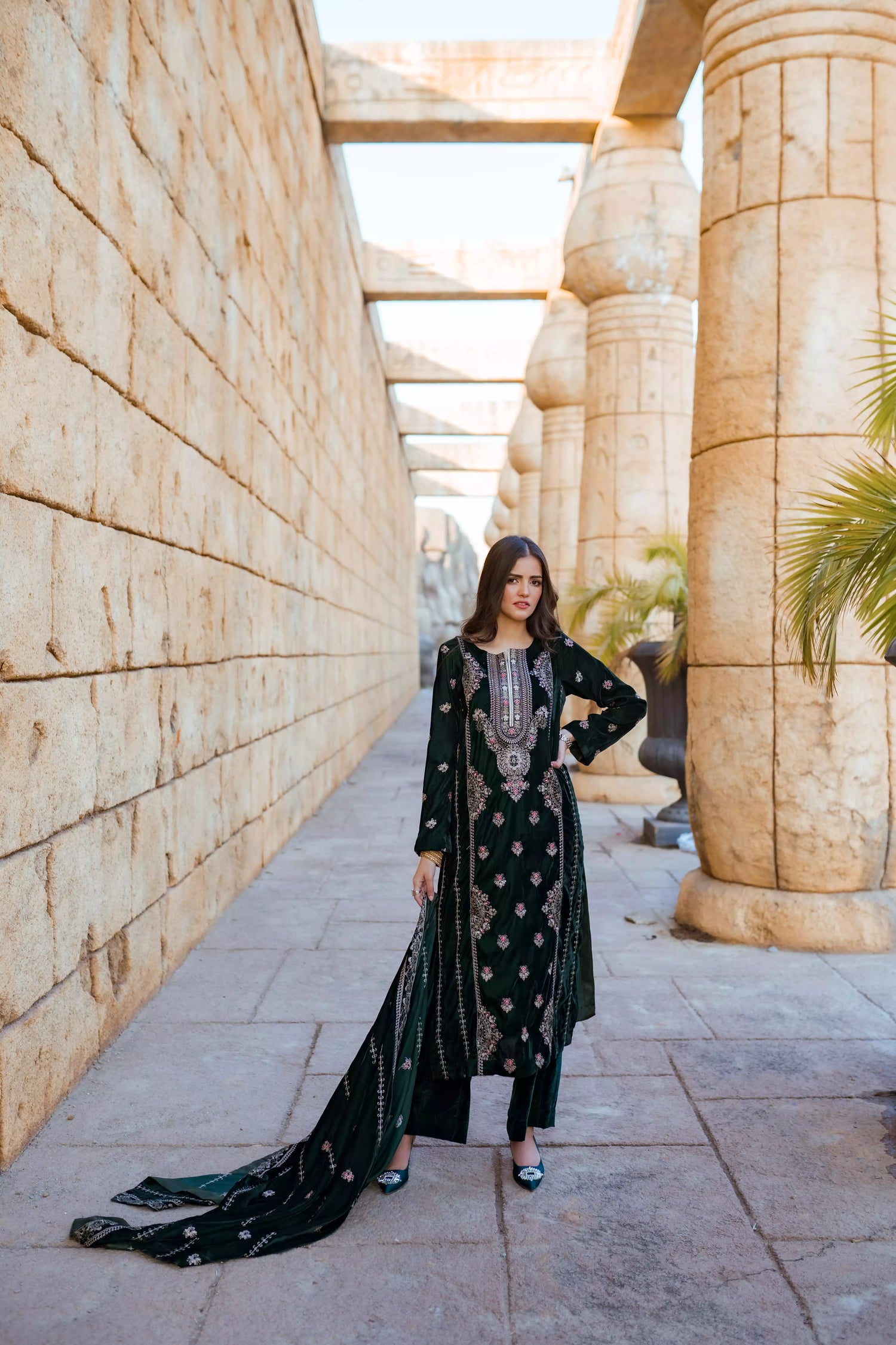Emerald green velvet suit with cream thread embroidery, paired with an embroidered shawl and plain velvet pants for an elegant, luxurious look.