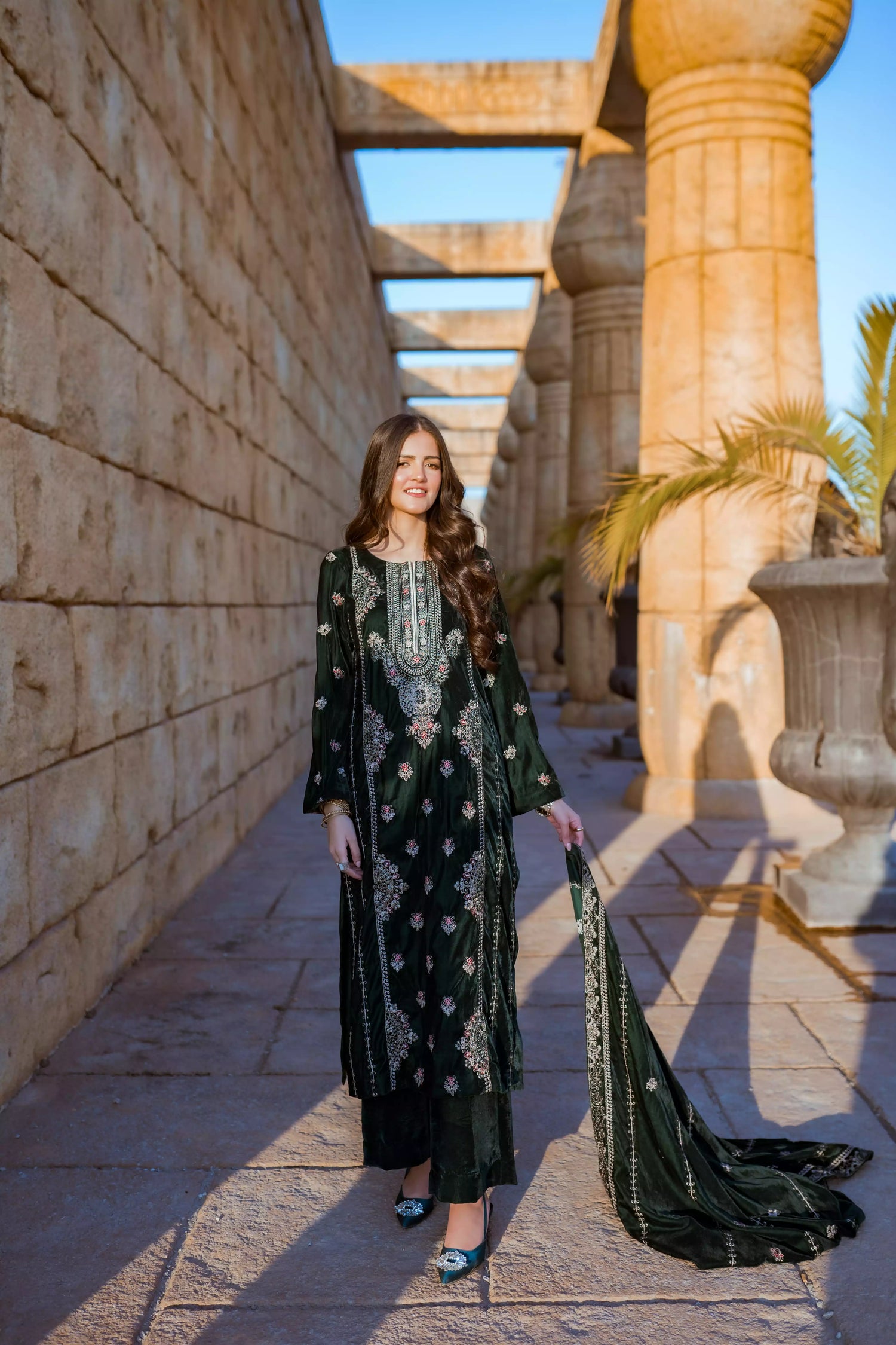Emerald green velvet suit with cream thread embroidery, paired with an embroidered shawl and plain velvet pants for an elegant, luxurious look.