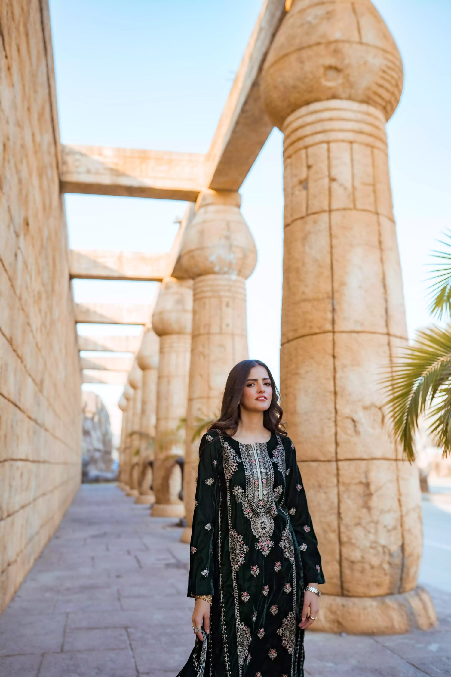 Emerald green velvet suit with cream thread embroidery, paired with an embroidered shawl and plain velvet pants for an elegant, luxurious look.