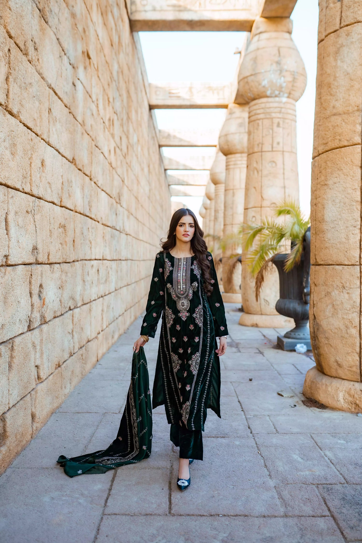 Emerald green velvet suit with cream thread embroidery, paired with an embroidered shawl and plain velvet pants for an elegant, luxurious look.