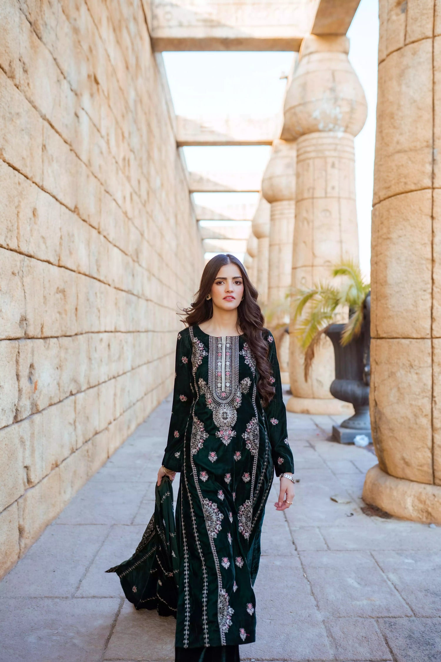 Emerald green velvet suit with cream thread embroidery, paired with an embroidered shawl and plain velvet pants for an elegant, luxurious look.