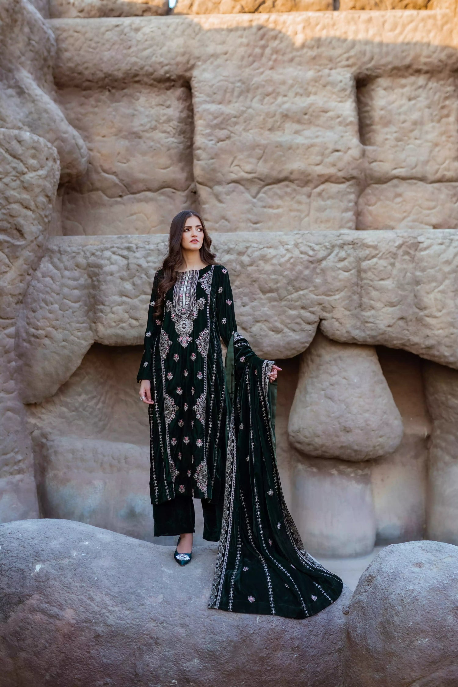 Emerald green velvet suit with cream thread embroidery, paired with an embroidered shawl and plain velvet pants for an elegant, luxurious look.