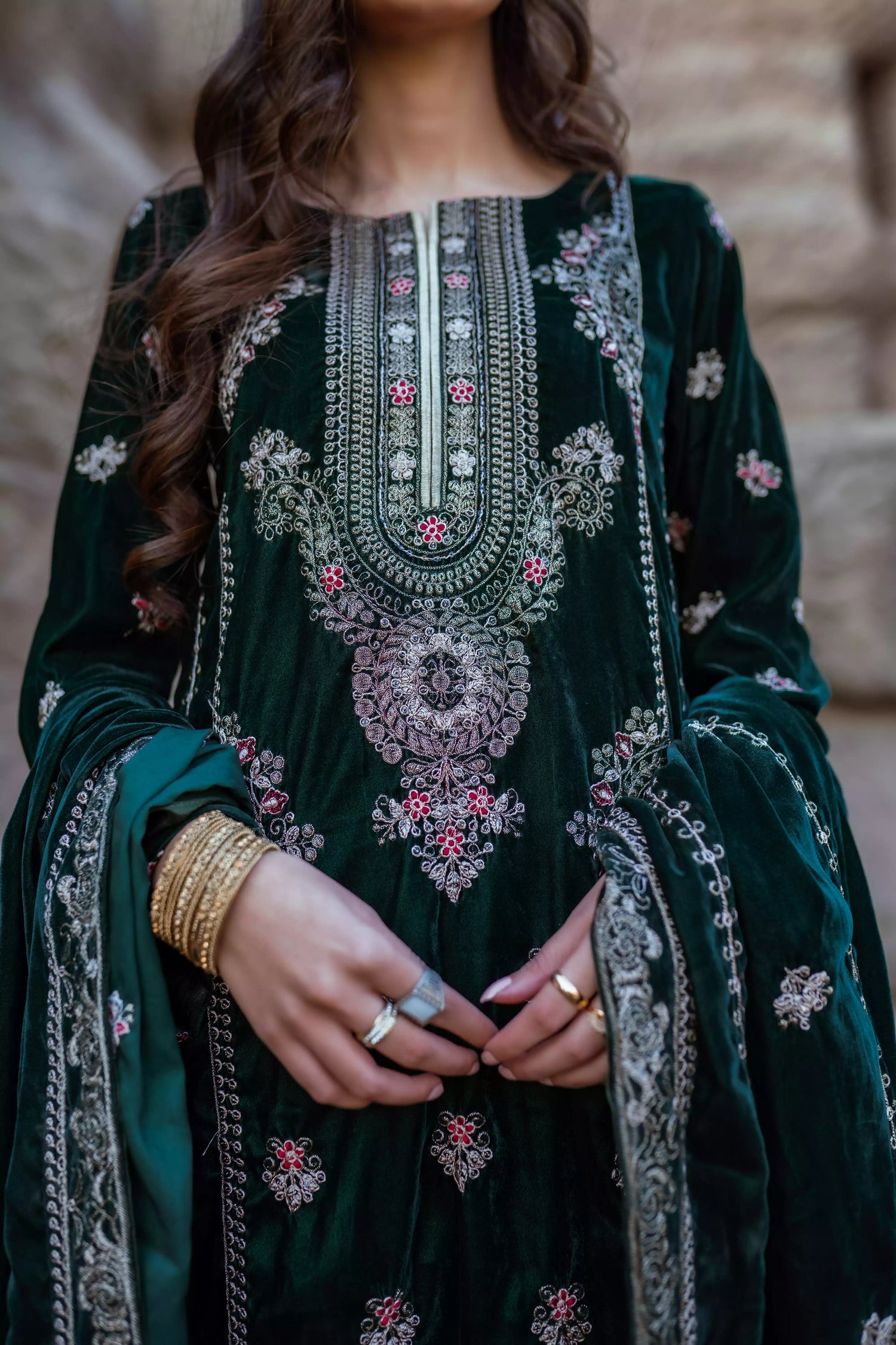 Emerald green velvet suit with cream thread embroidery, paired with an embroidered shawl and plain velvet pants for an elegant, luxurious look.