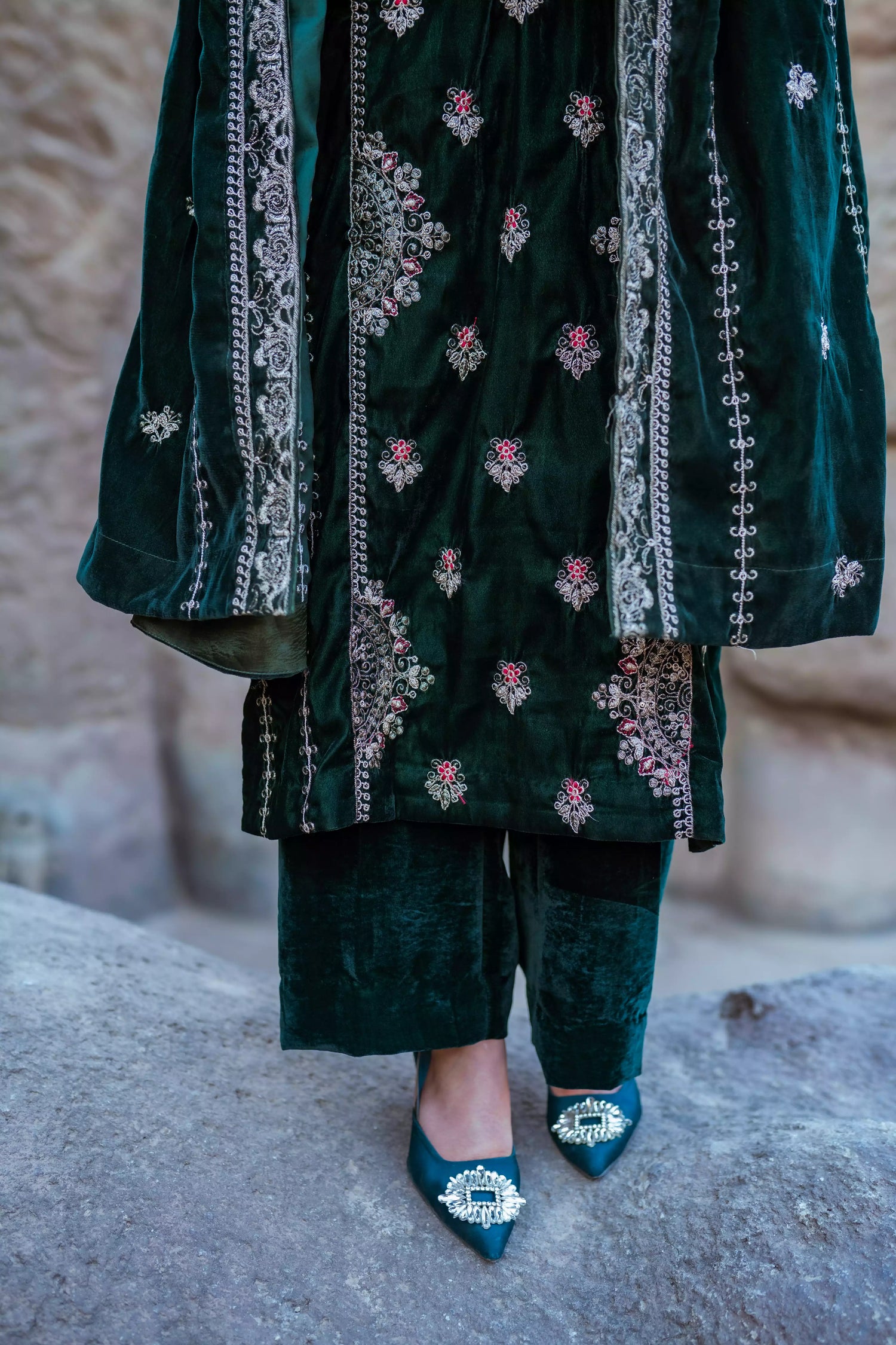 Emerald green velvet suit with cream thread embroidery, paired with an embroidered shawl and plain velvet pants for an elegant, luxurious look.