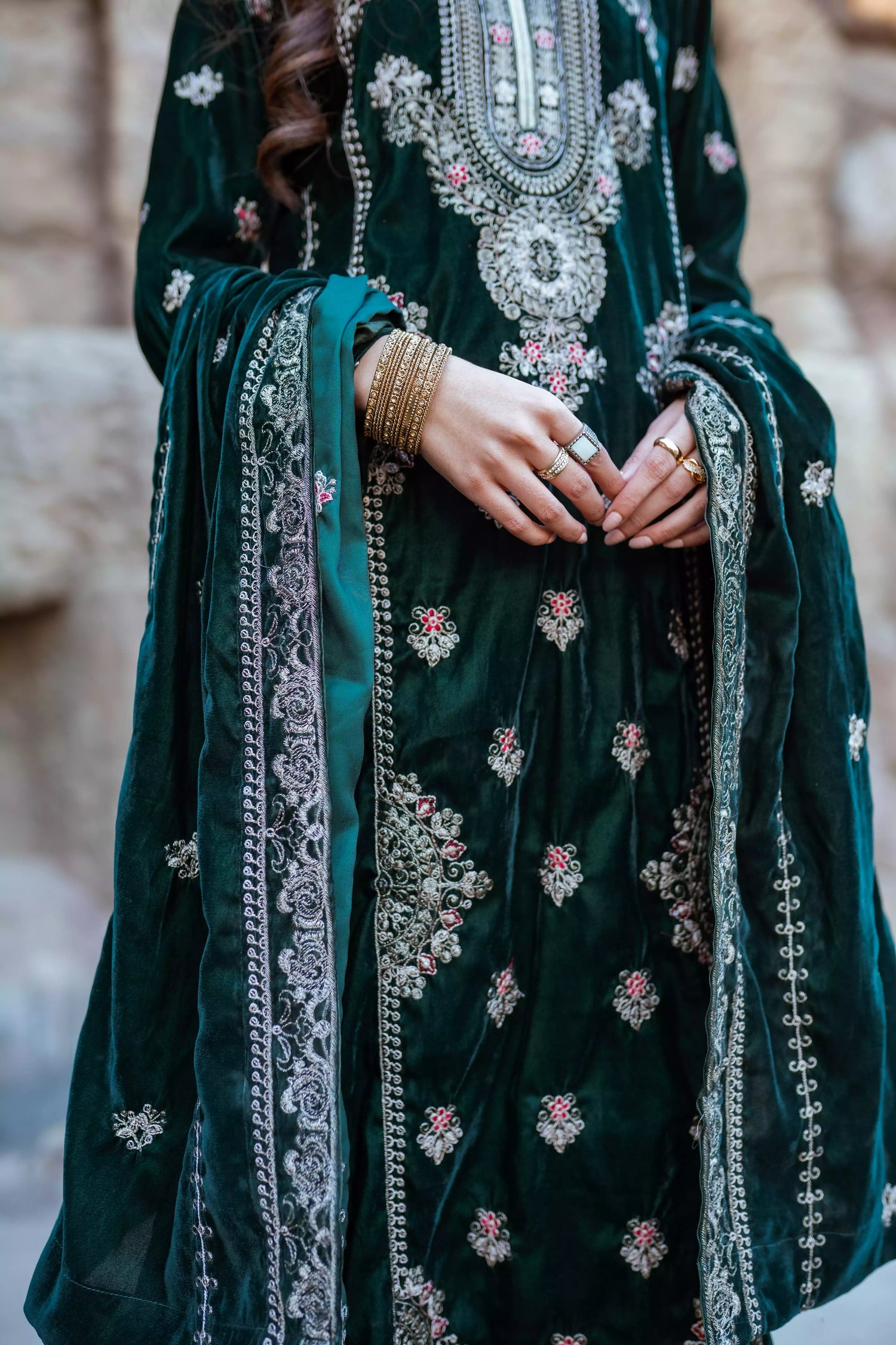 Emerald green velvet suit with cream thread embroidery, paired with an embroidered shawl and plain velvet pants for an elegant, luxurious look.