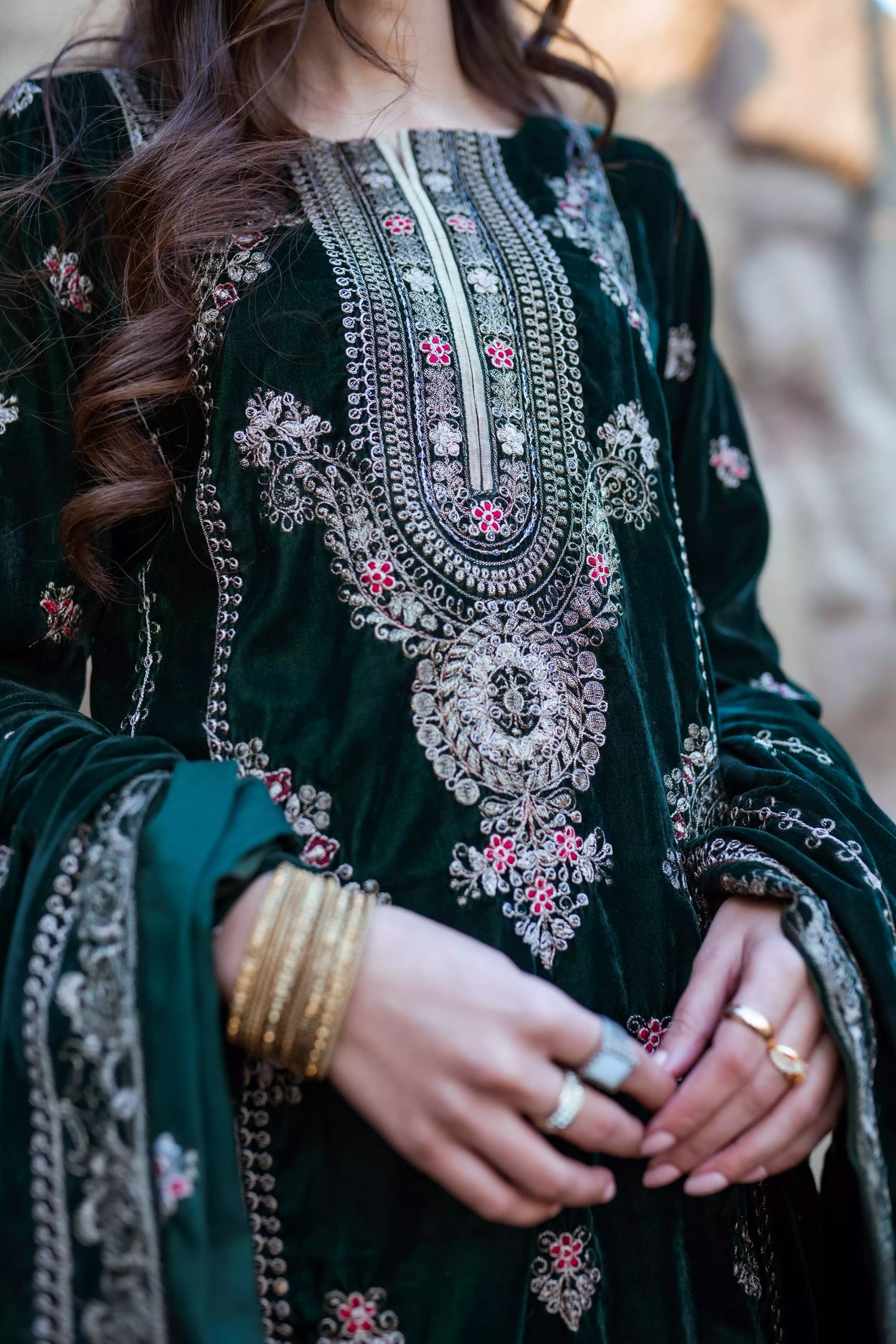 Emerald green velvet suit with cream thread embroidery, paired with an embroidered shawl and plain velvet pants for an elegant, luxurious look.