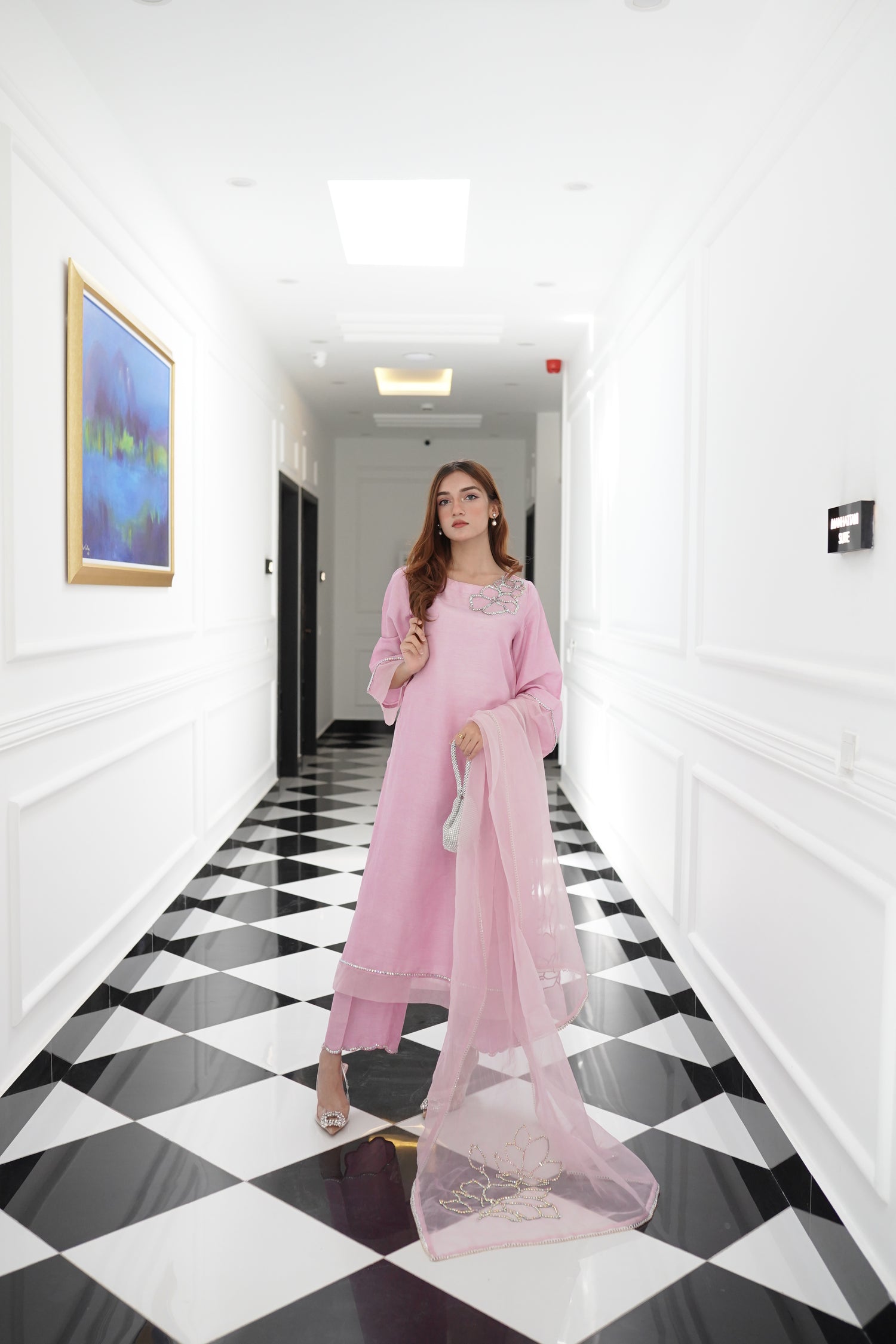 A sophisticated light pink dress with floral rhinestones showcasing style and elegance.