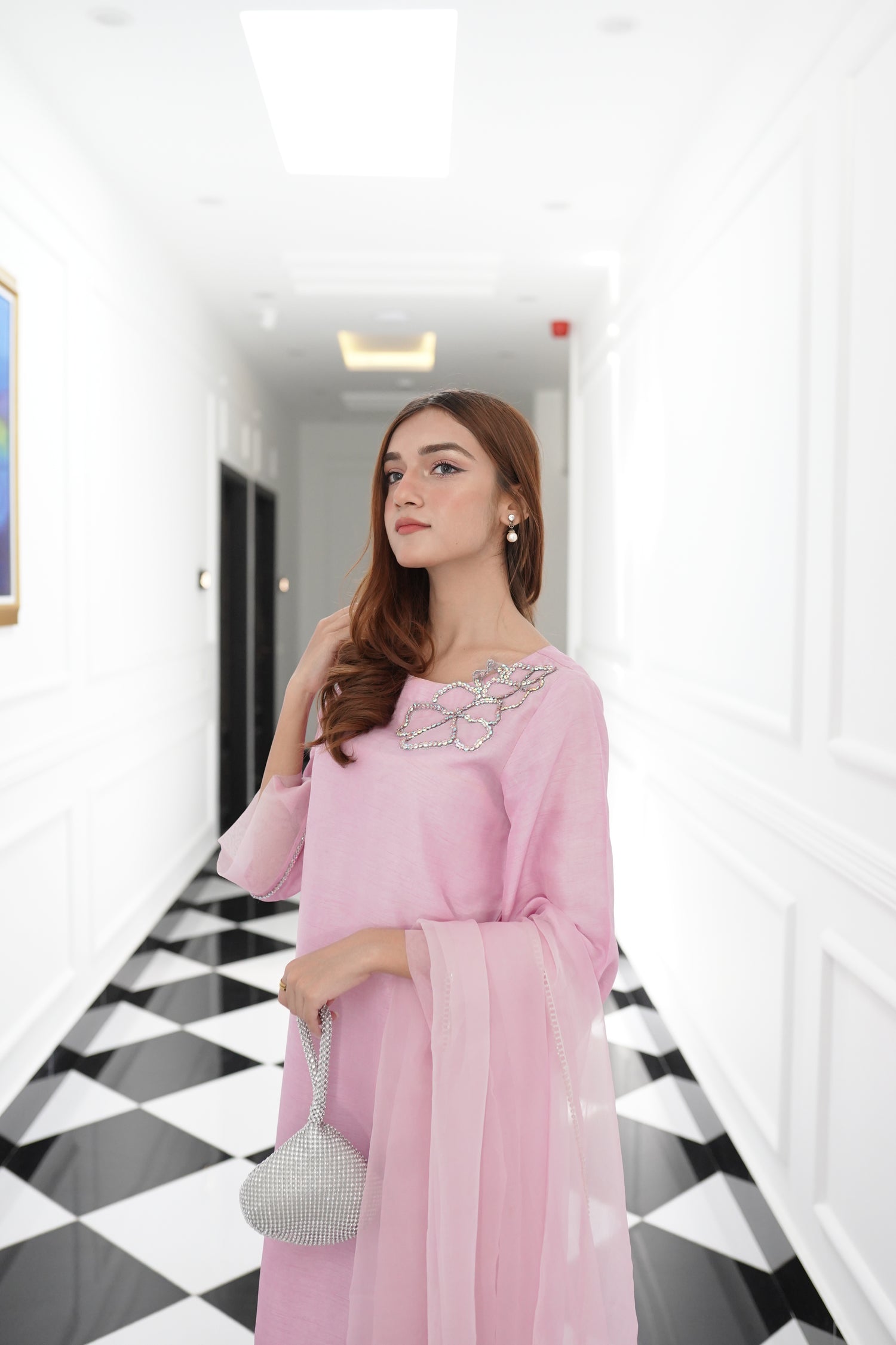 A sophisticated light pink dress with floral rhinestones showcasing style and elegance.